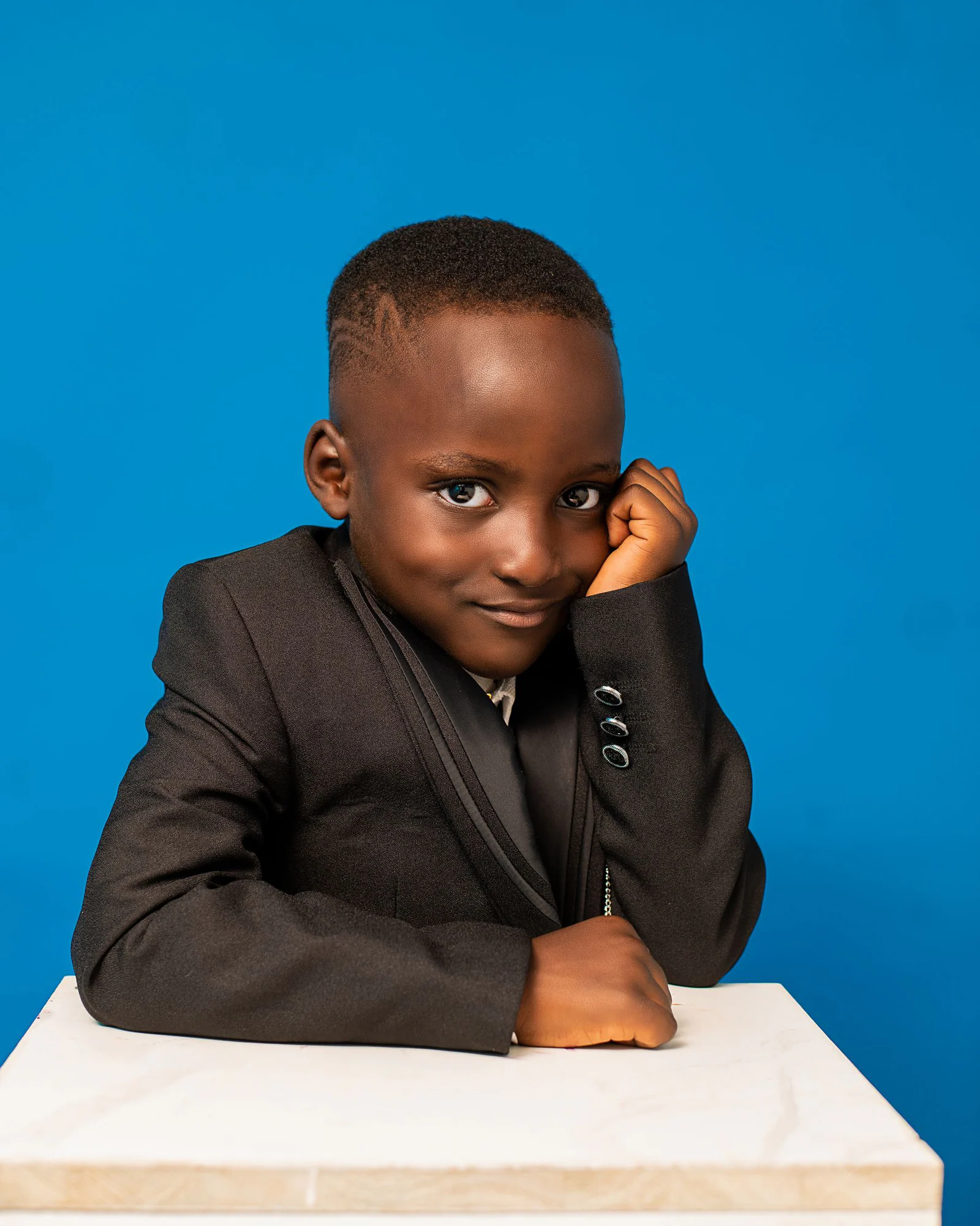Confident young boy in formal suit portrait