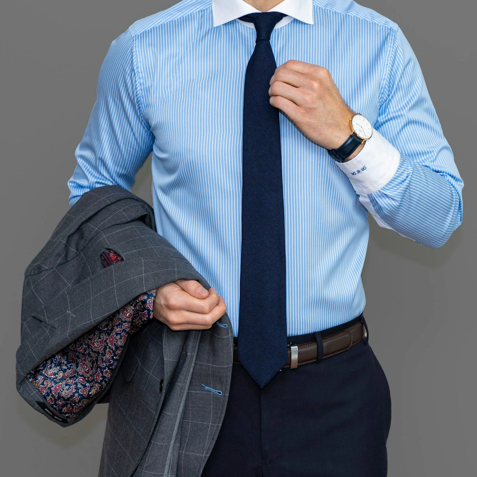 Man in a light blue business shirt and navy tie