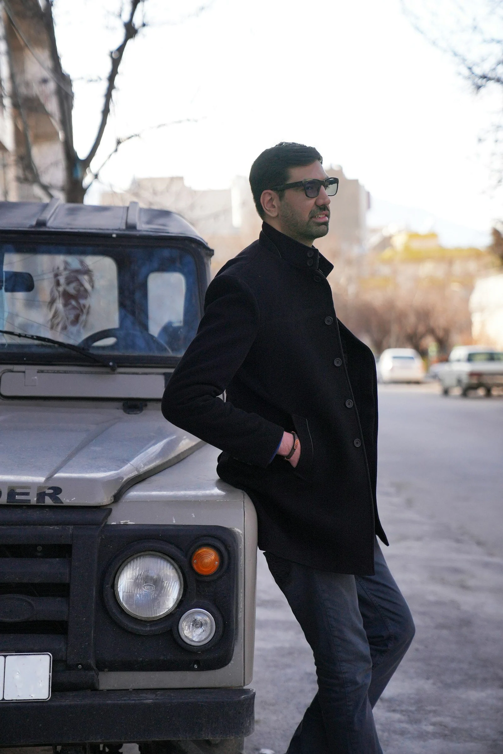 A man leaning on the hood of a truck