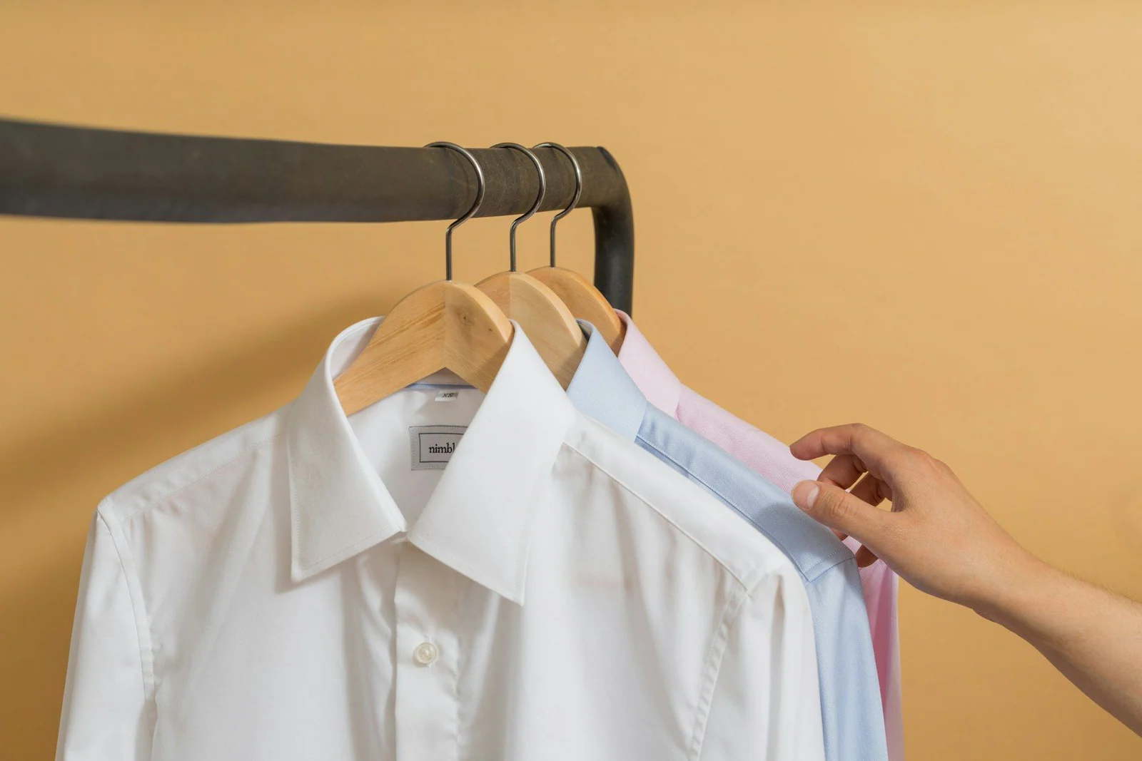 White button up shirt on black clothes hanger