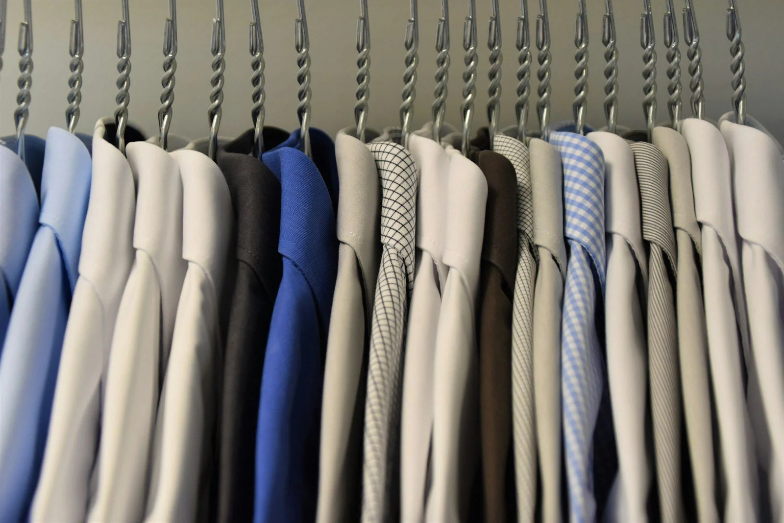Assorted color dress shirt lot on clothes hangers