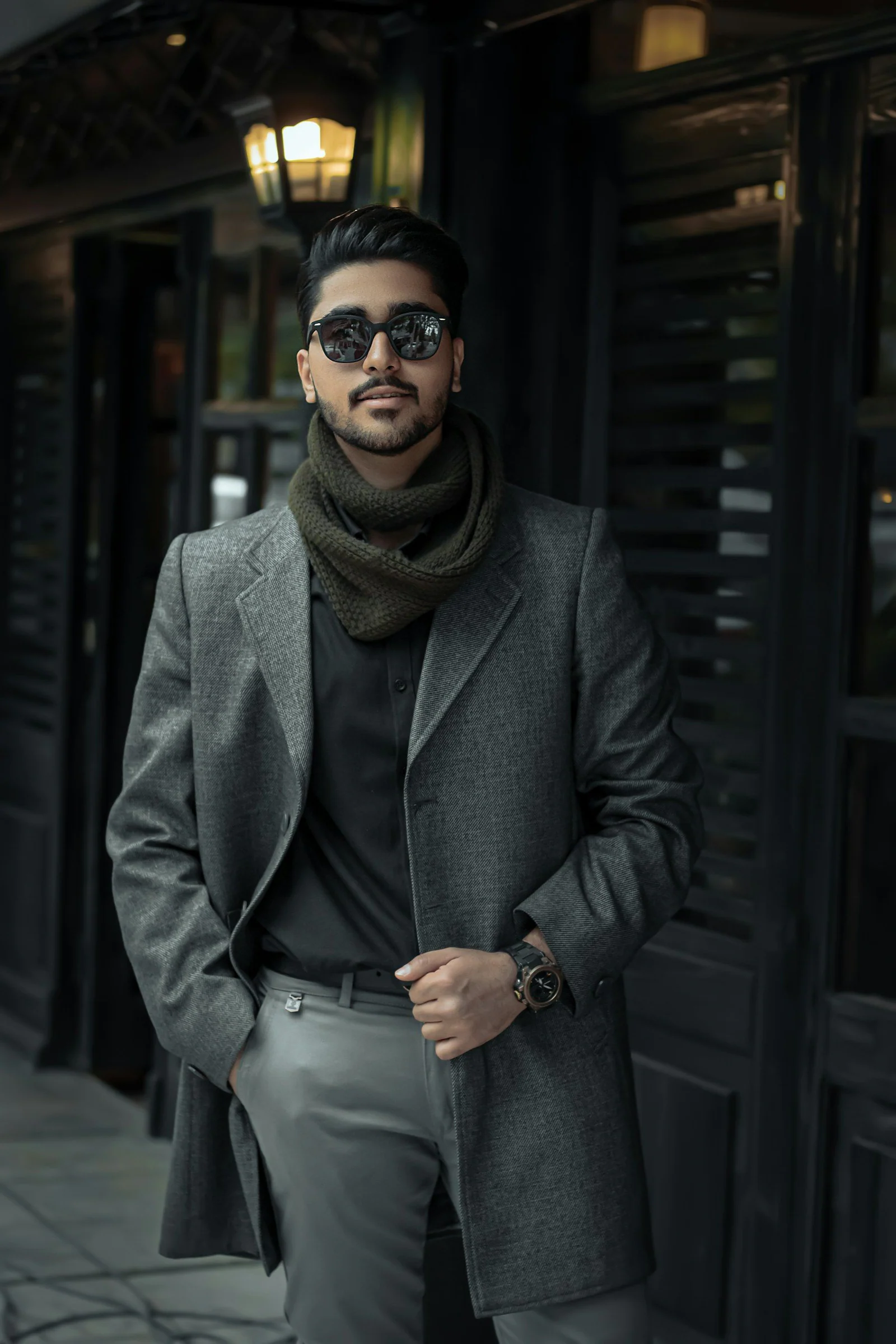 Woman in gray coat wearing black sunglasses