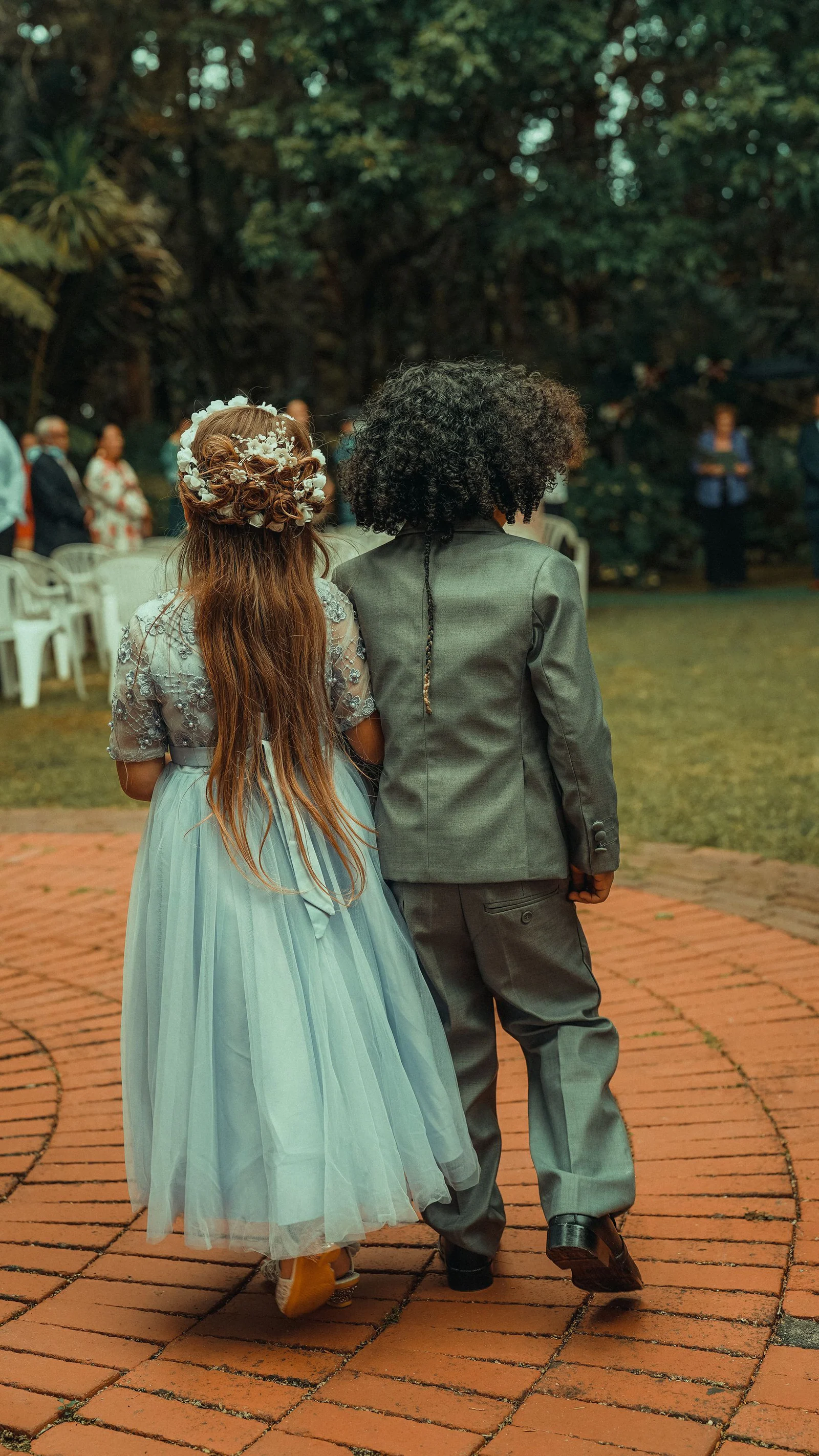Back view of children dressed elegantly on a wedding party