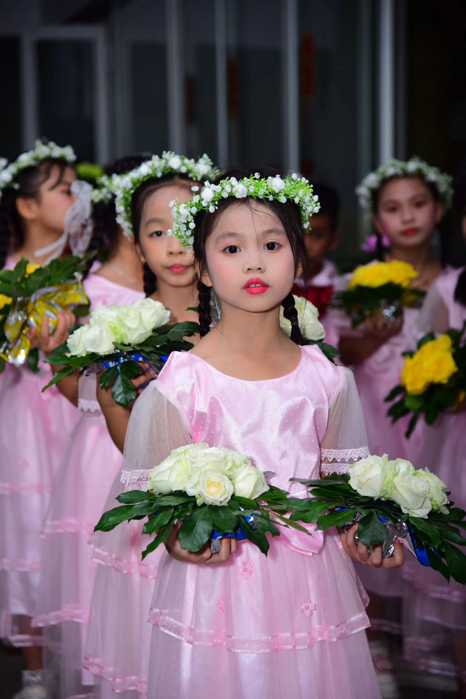 Children in flower crowns holding bouquets
