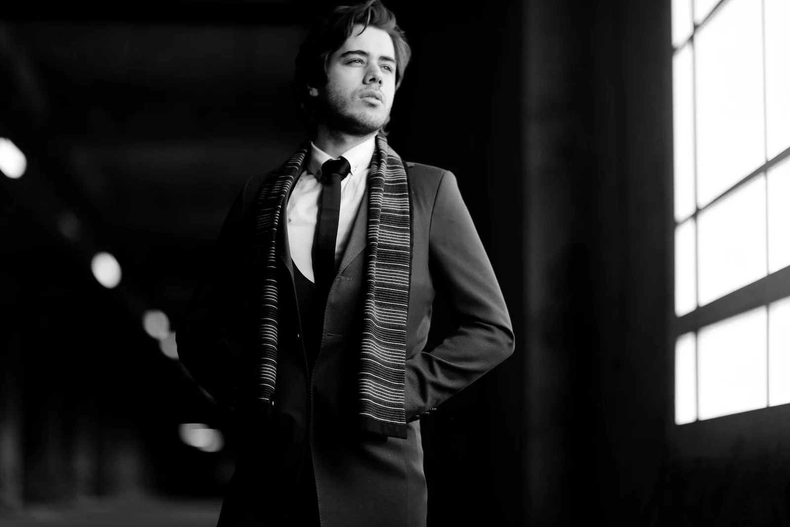 Man in suit jacket and dress pants in grayscale photography