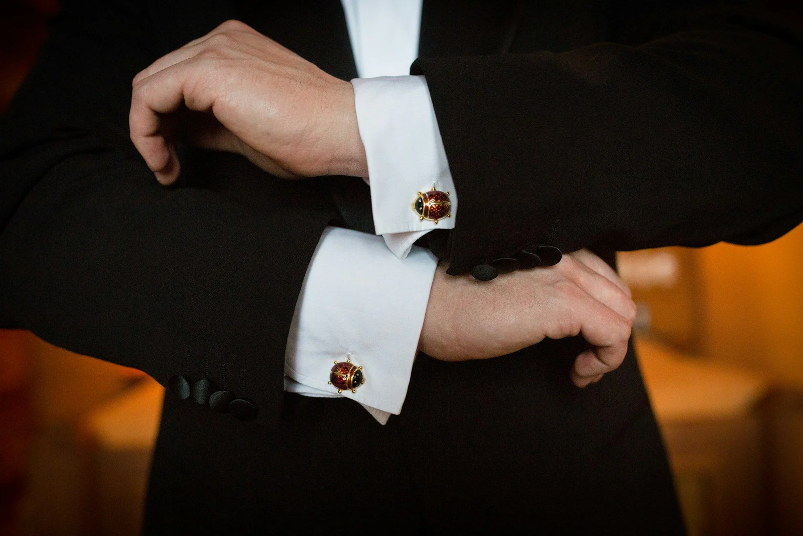 Person wearing white dress shirt and black and white beaded bracelet
