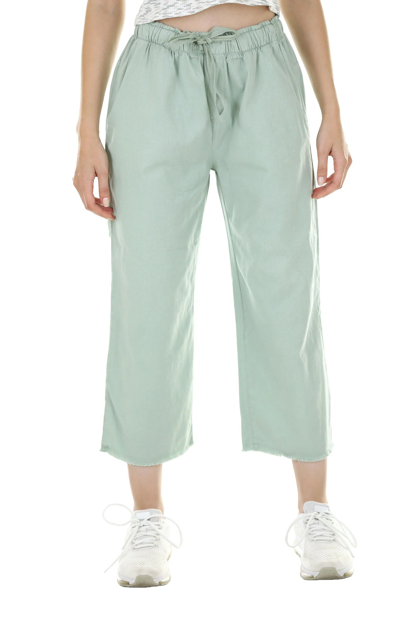 Person wearing light green cropped trousers