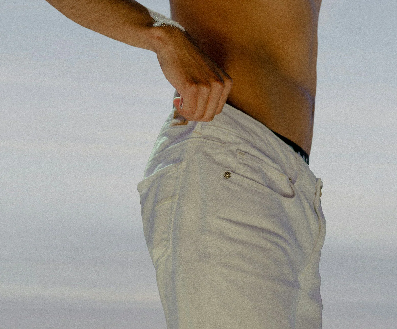 Topless man in white shorts