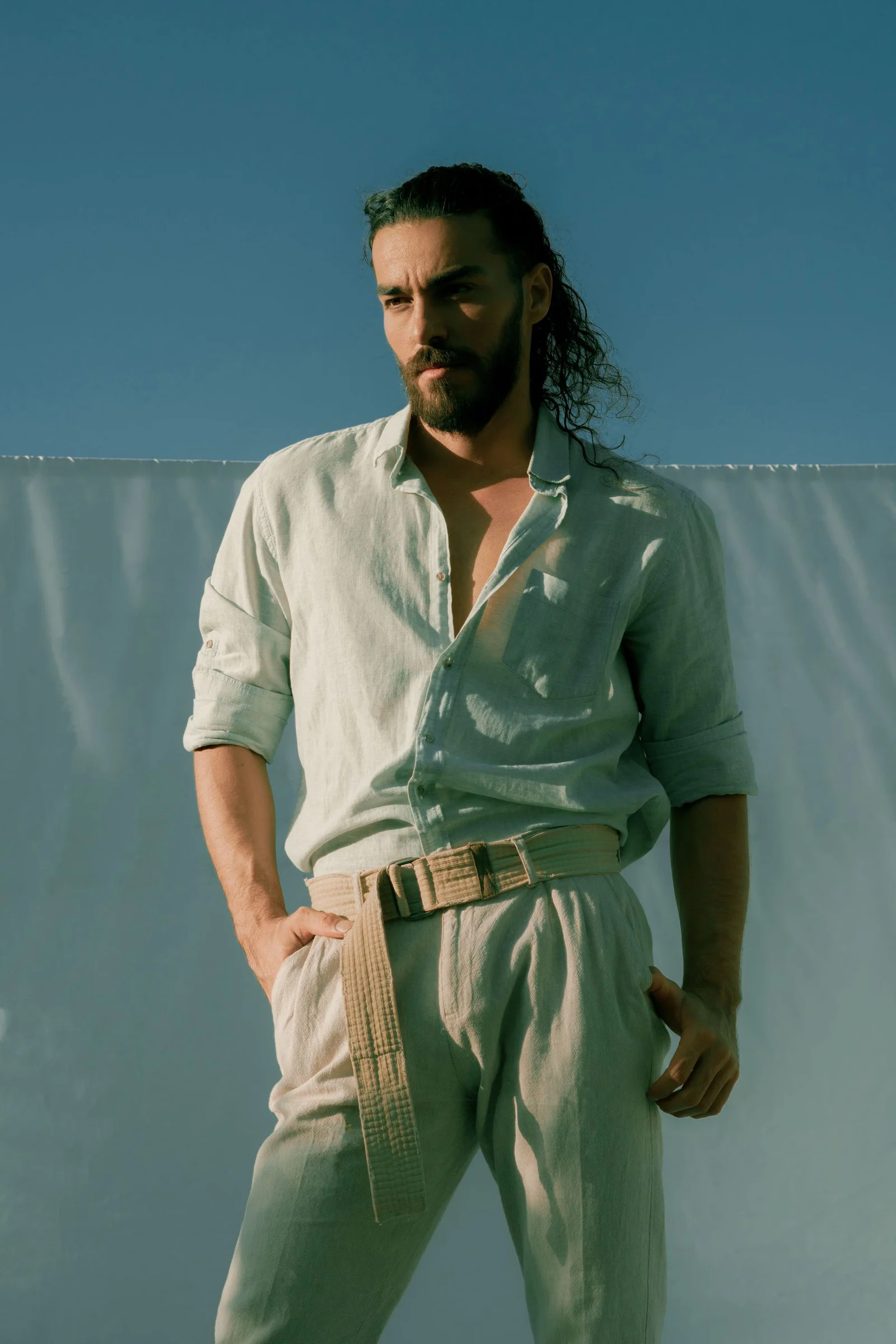 Thoughtful pensive man near hanging sheet