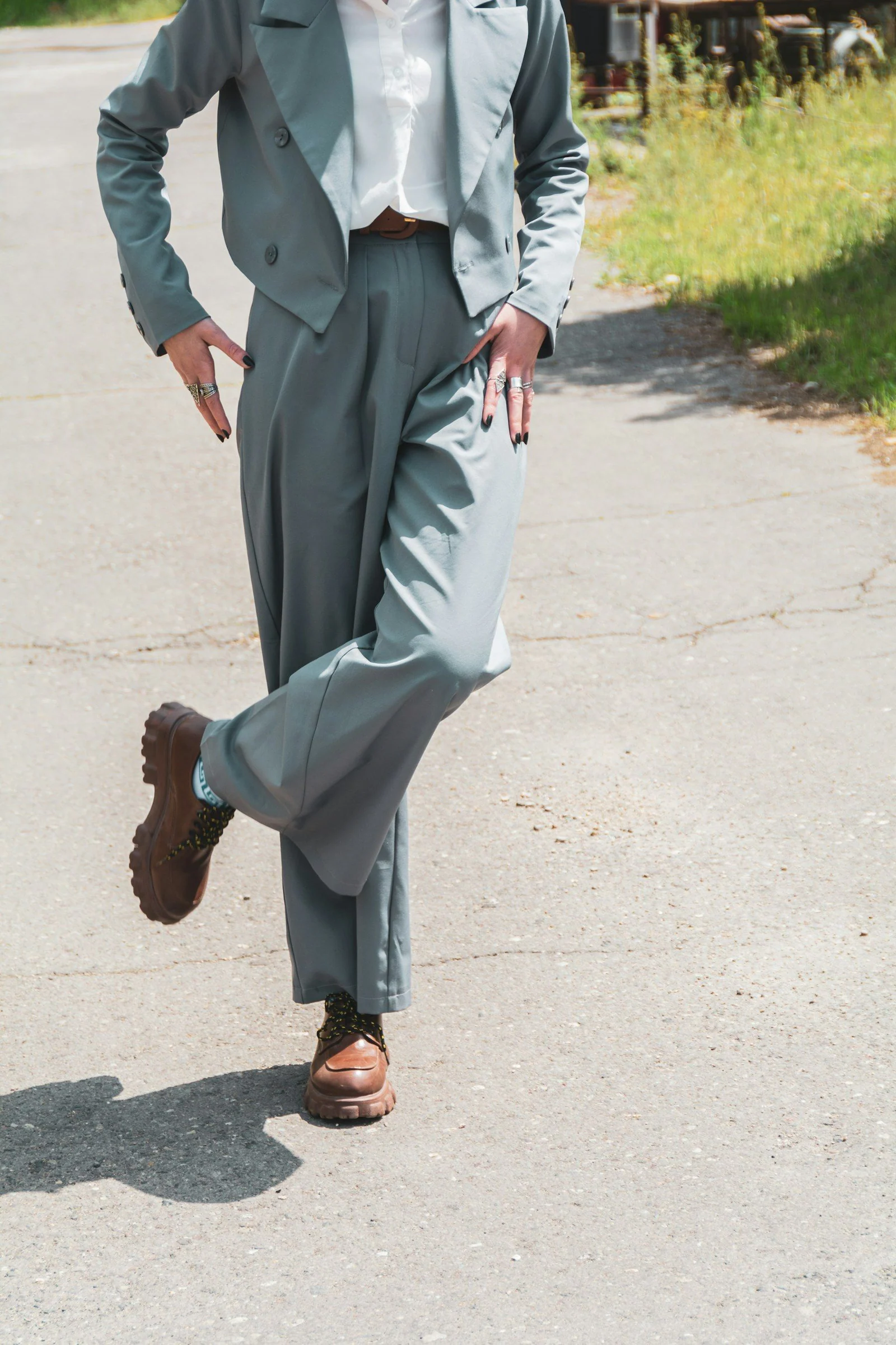 A man in a suit and tie walking down a street