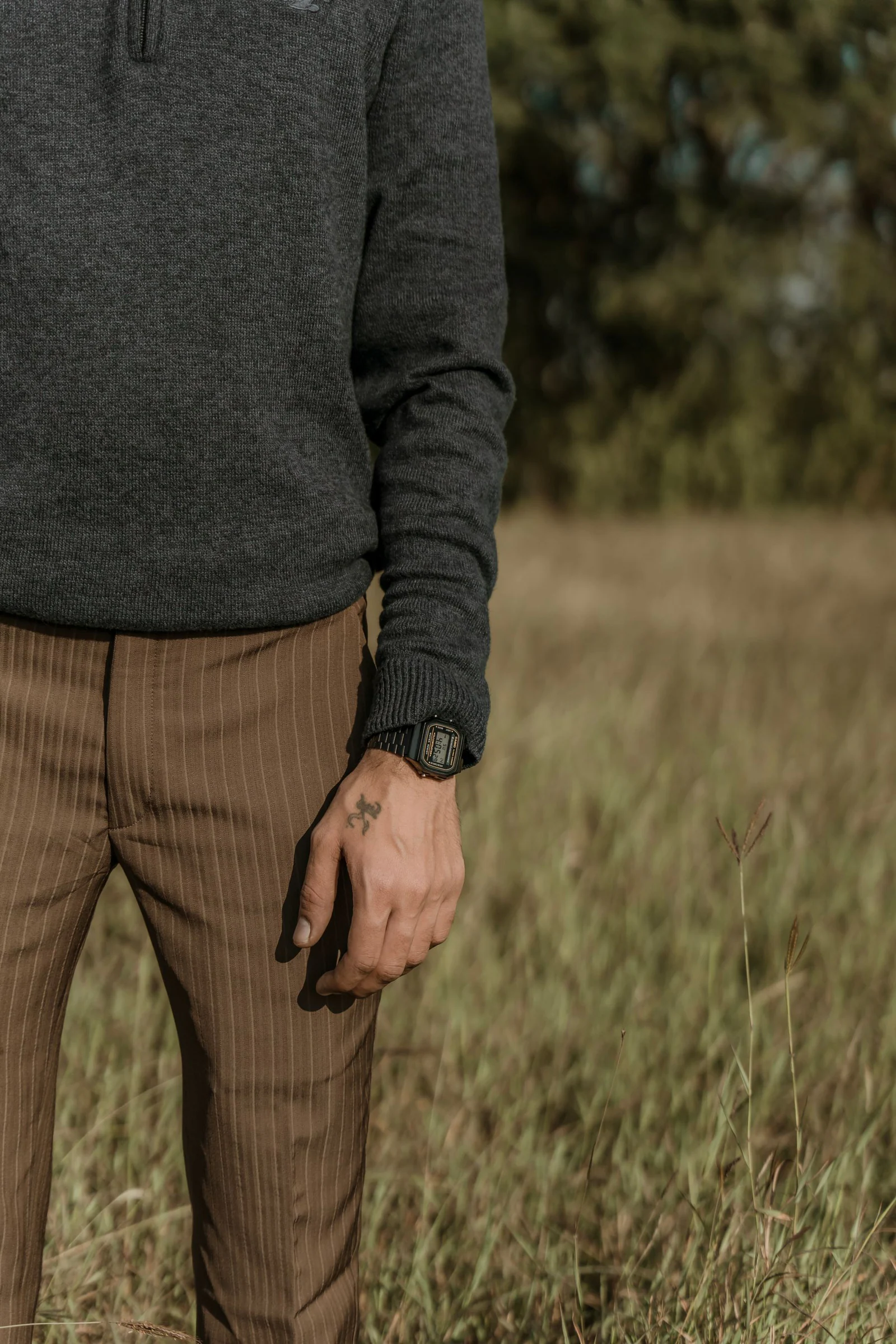 Tattoo and wristwatch on man hand