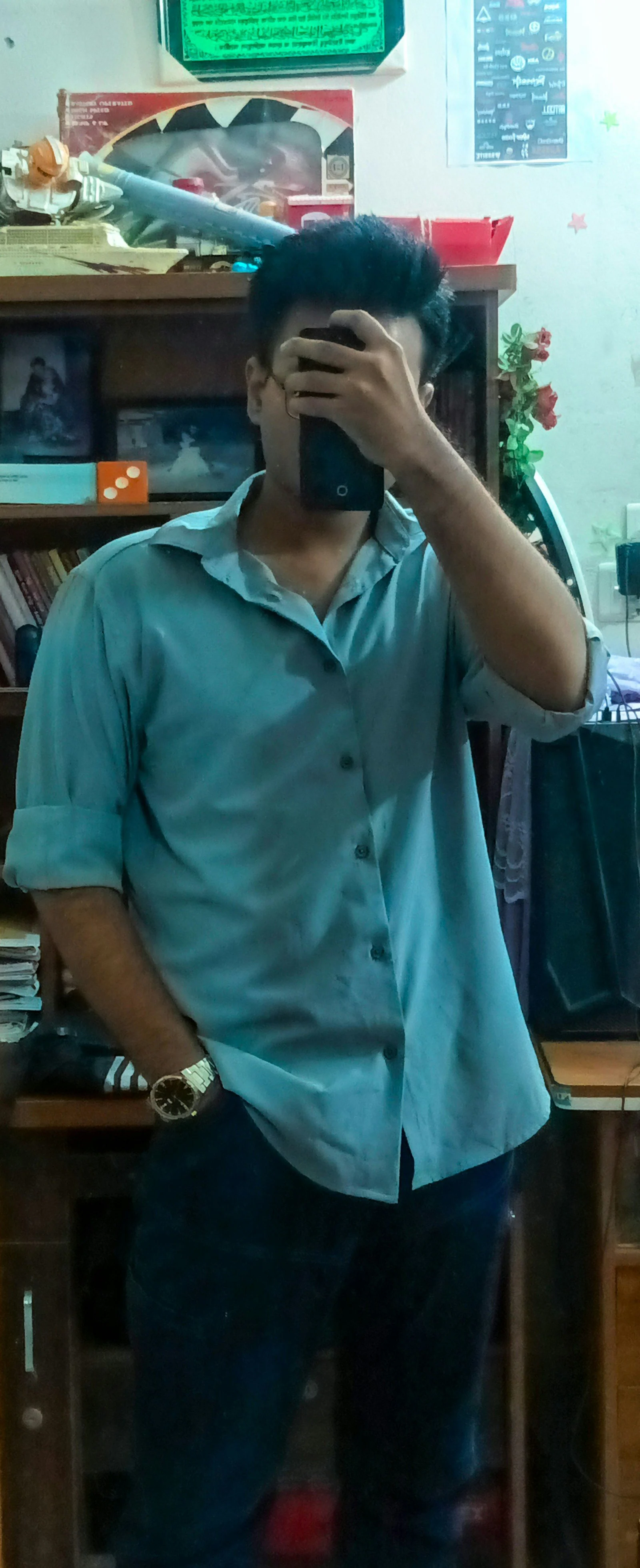 Person in blue shirt taking selfie