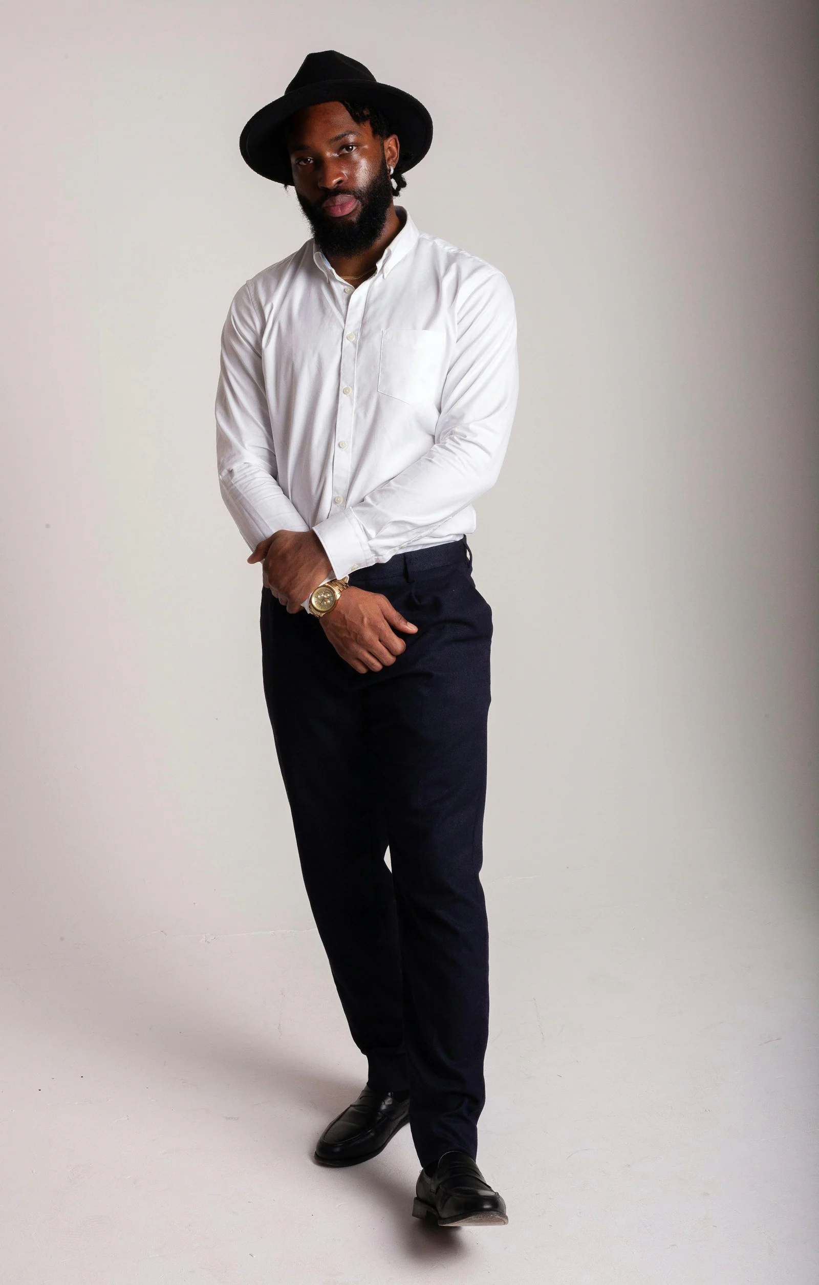 A man in a white shirt and black hat