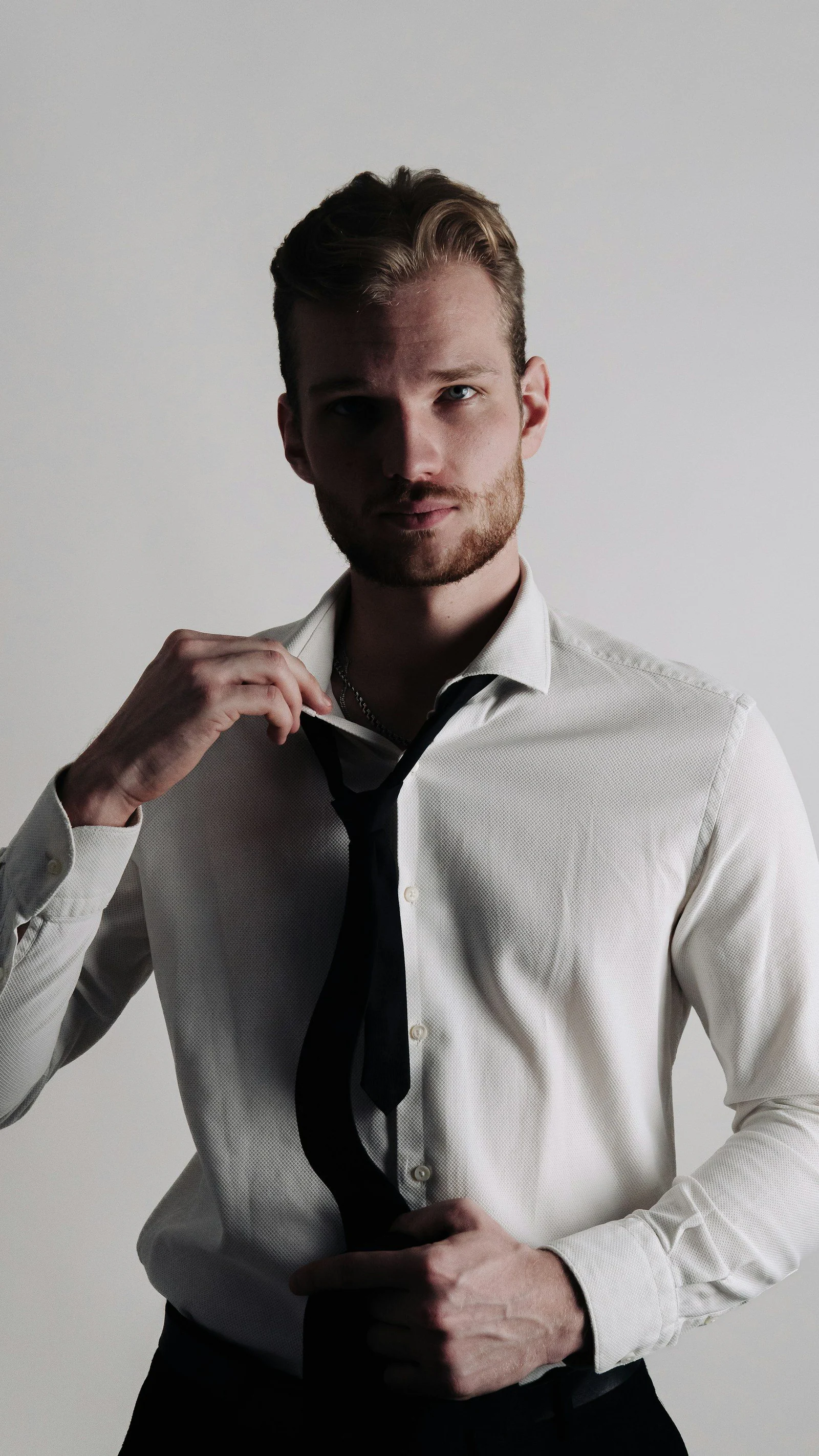 A man in a white shirt and black tie