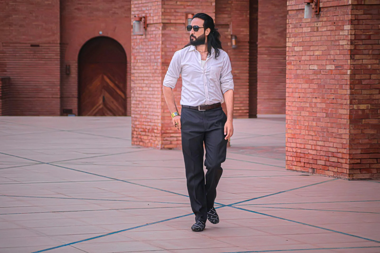 A man in a white shirt and black pants