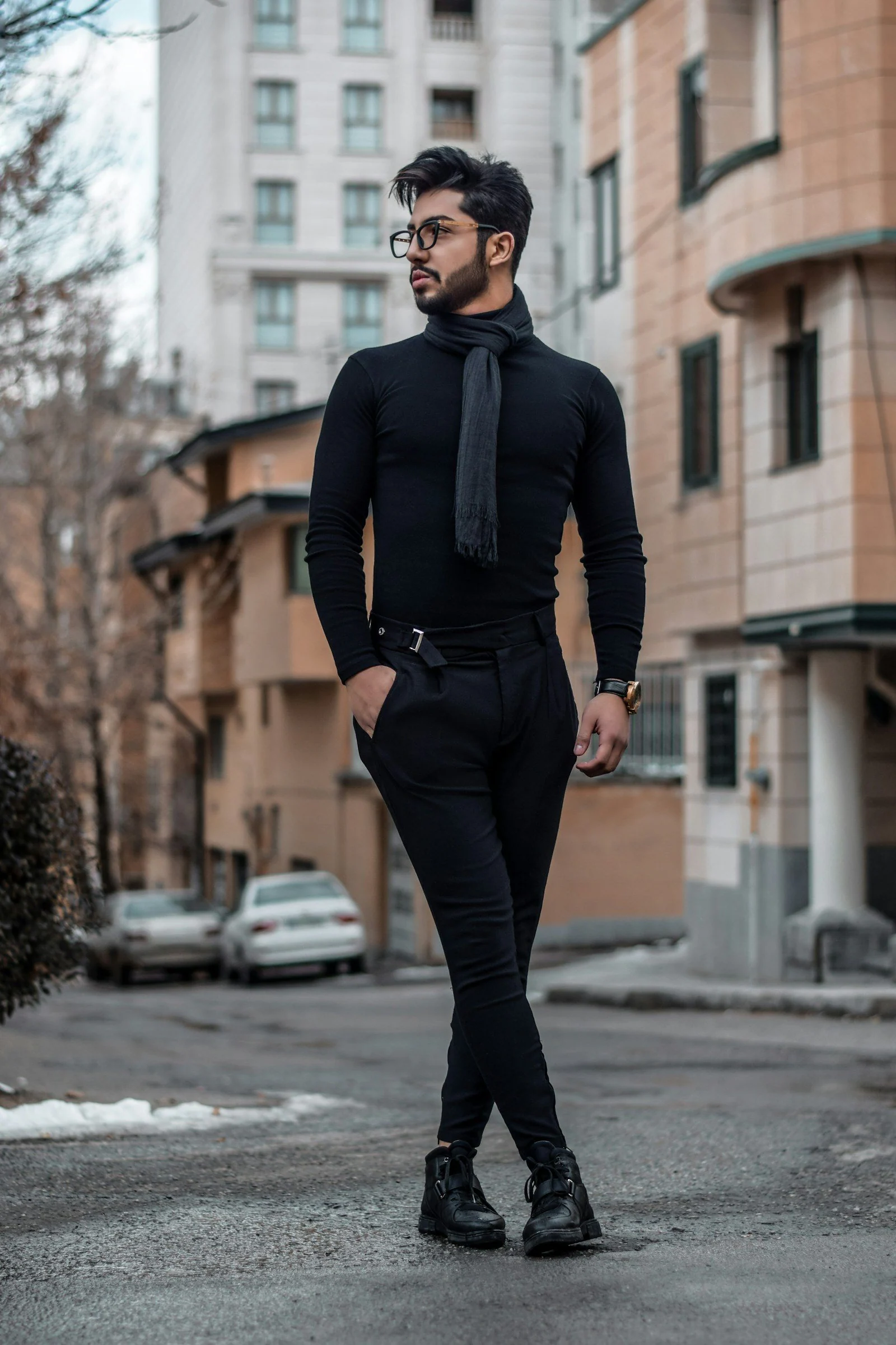 Man in black dress shirt necktie and pants standing on street