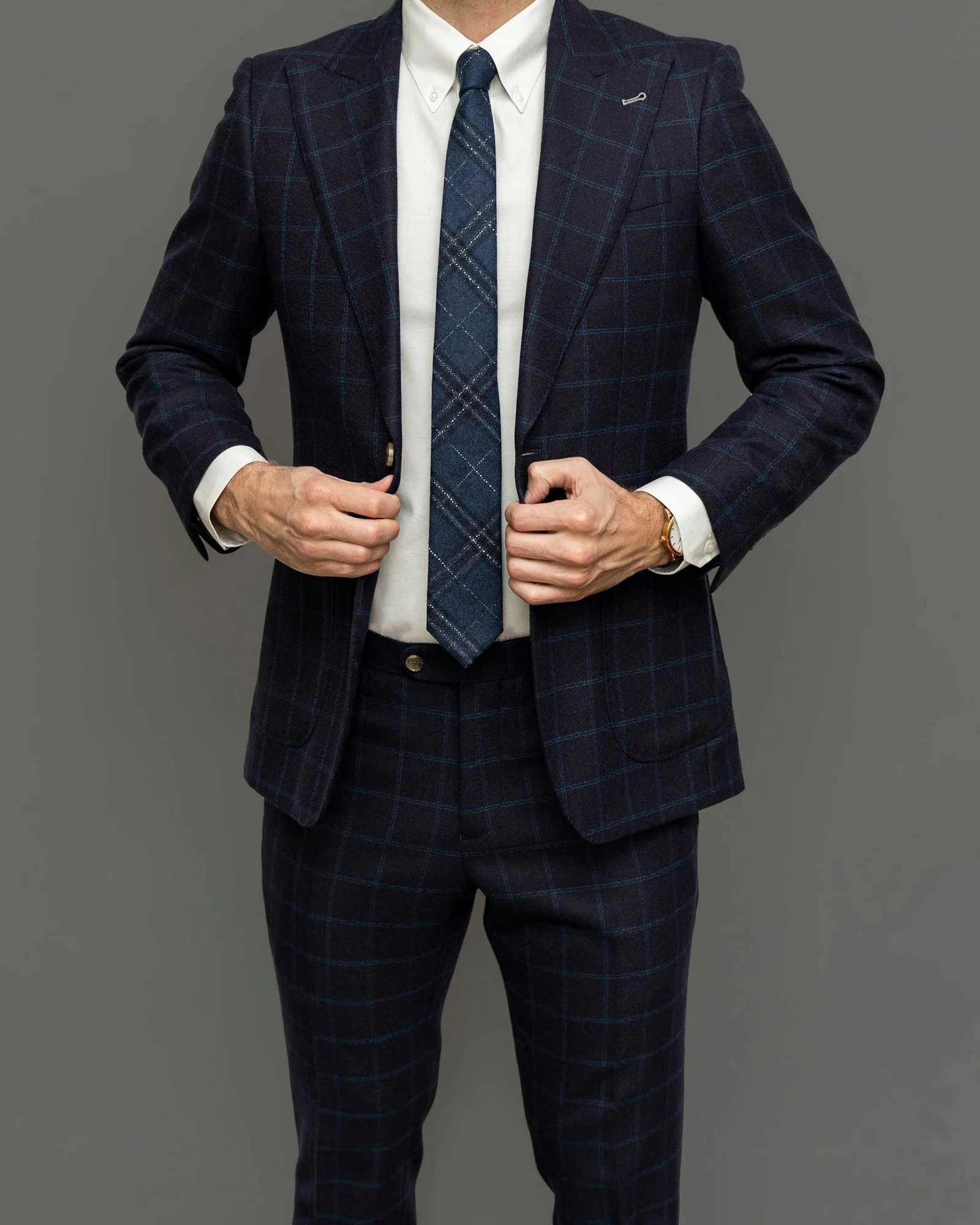 Man in black suit jacket and black and white striped necktie