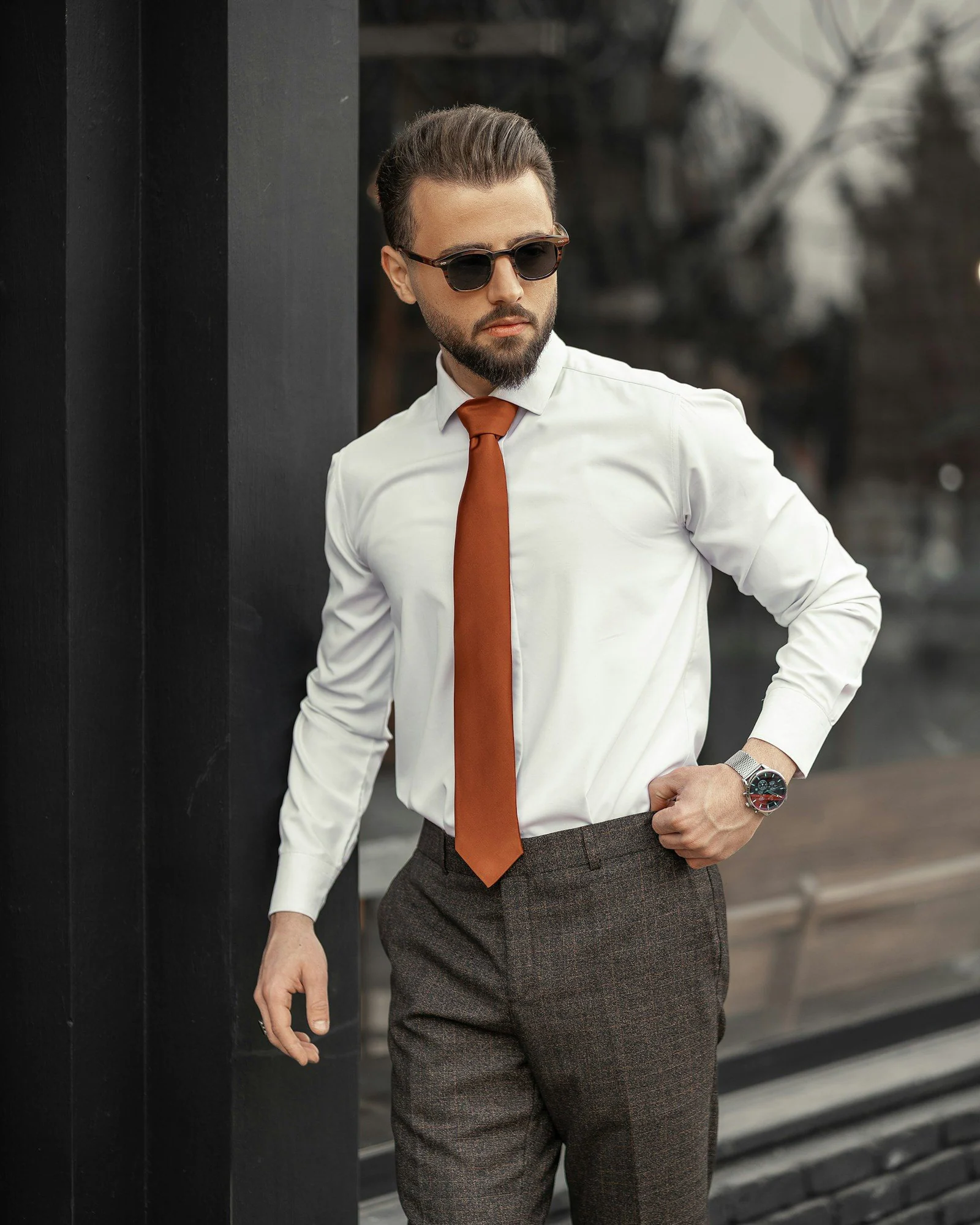 A man in a white shirt and orange tie