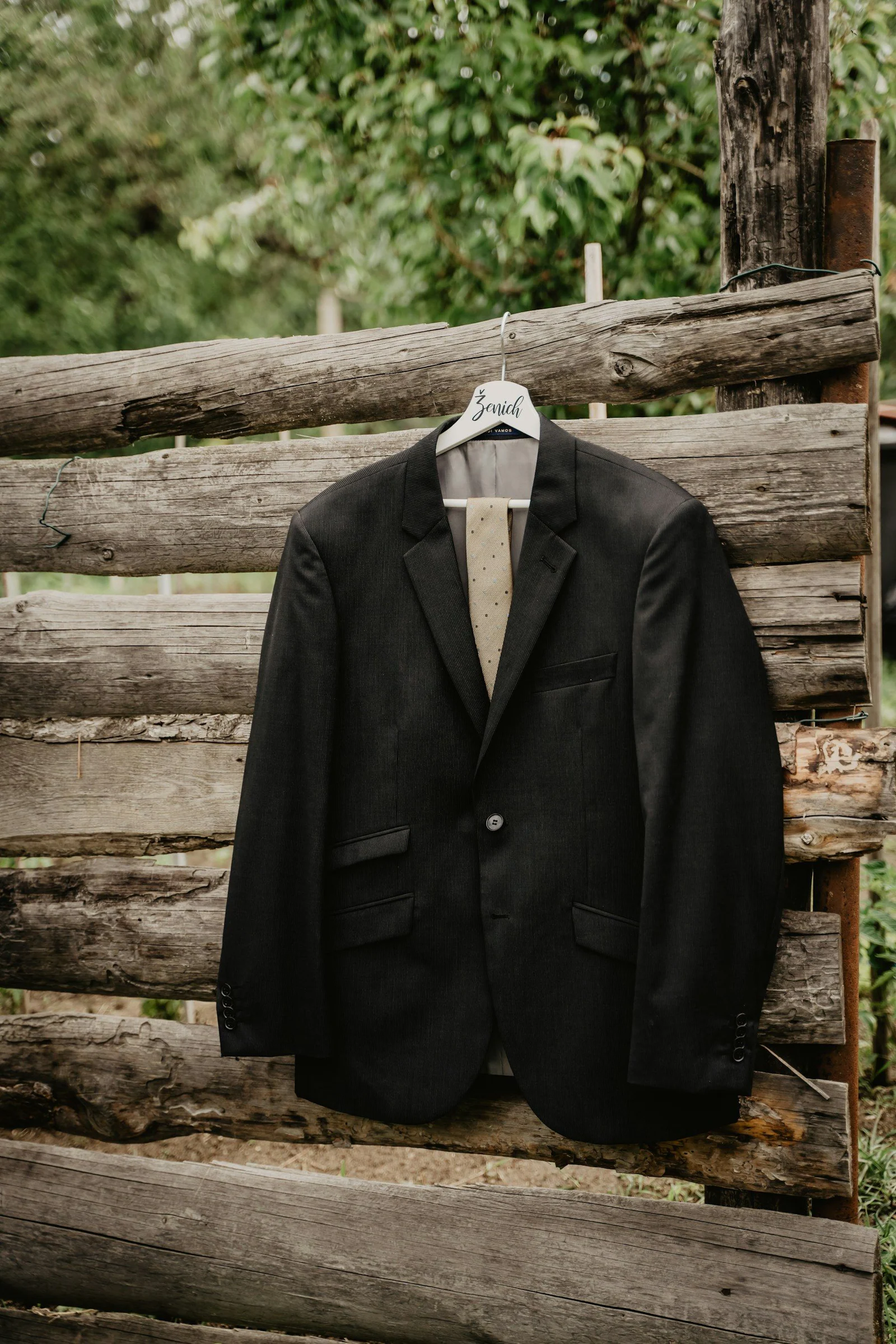 Black suit jacket on white plastic clothes hanger