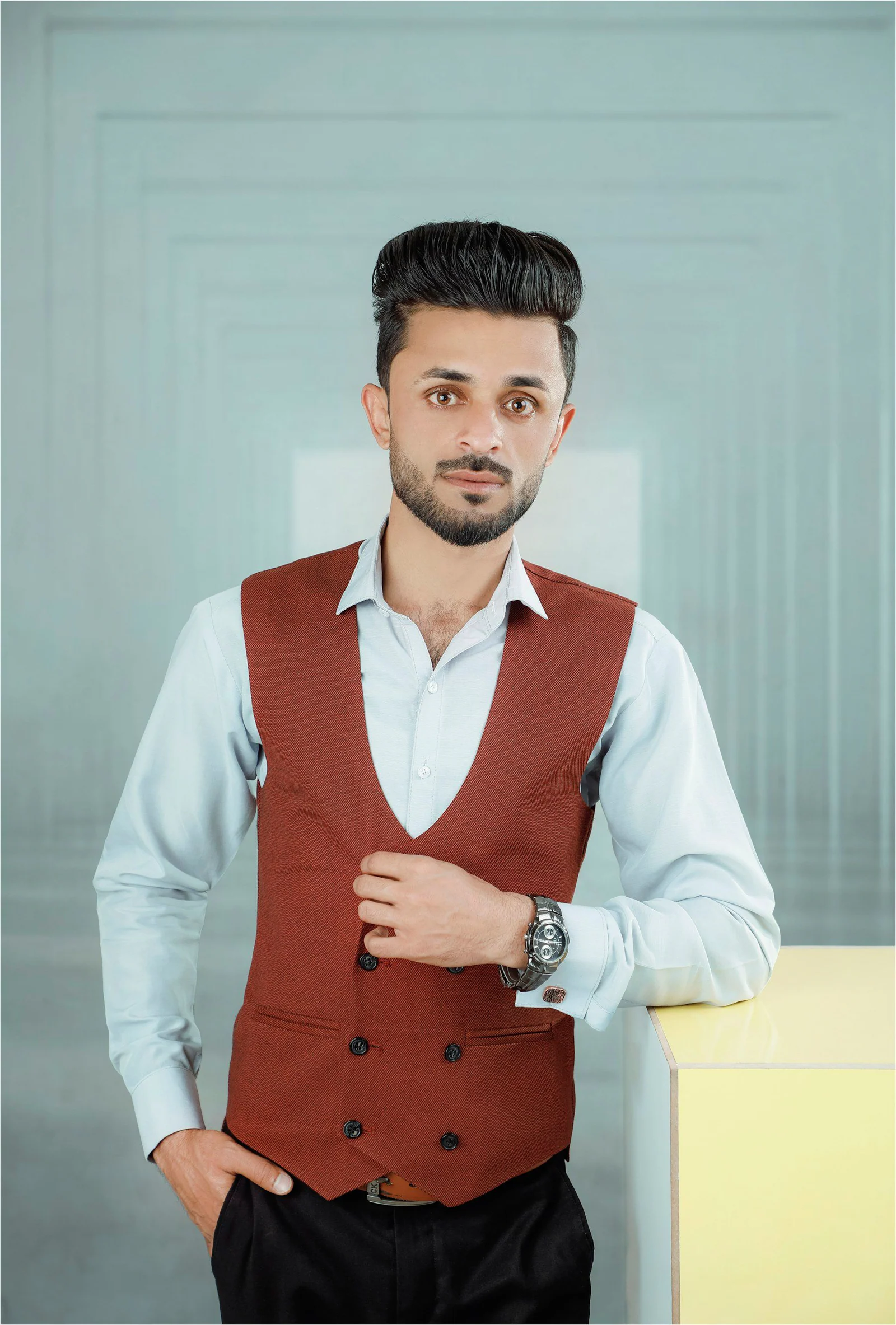 A man in a red vest and white shirt
