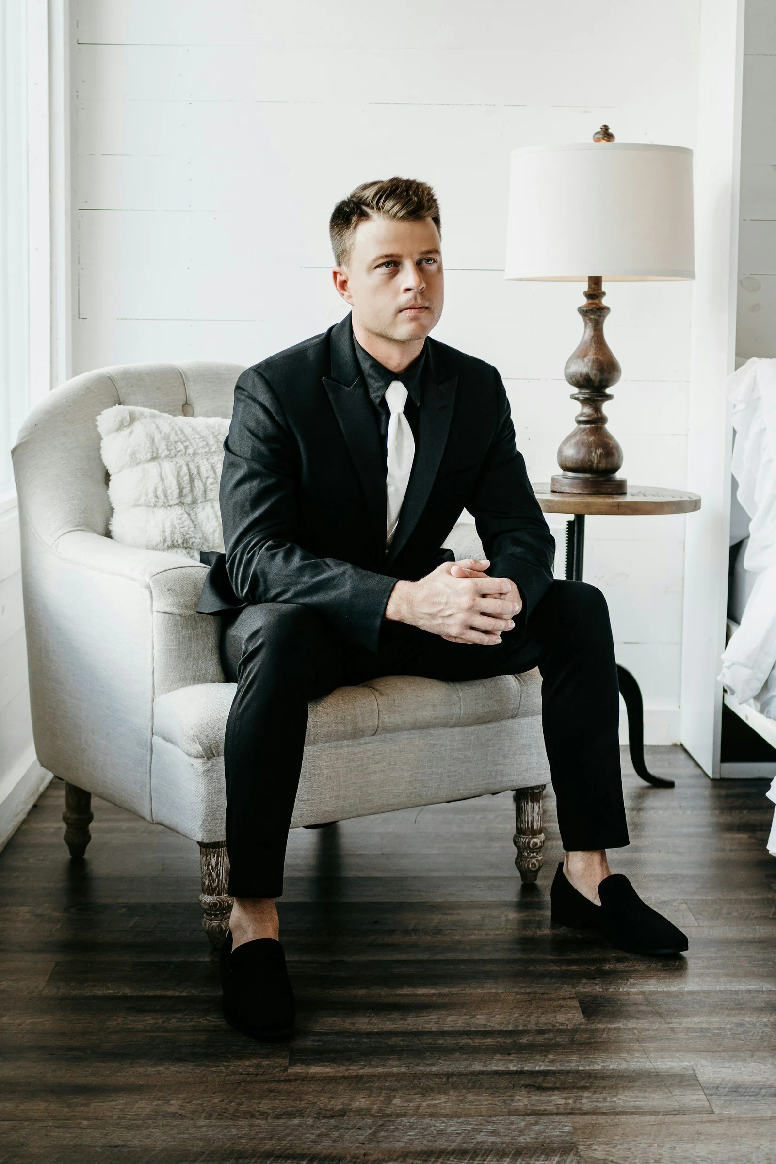 A man in a suit sitting on a chair