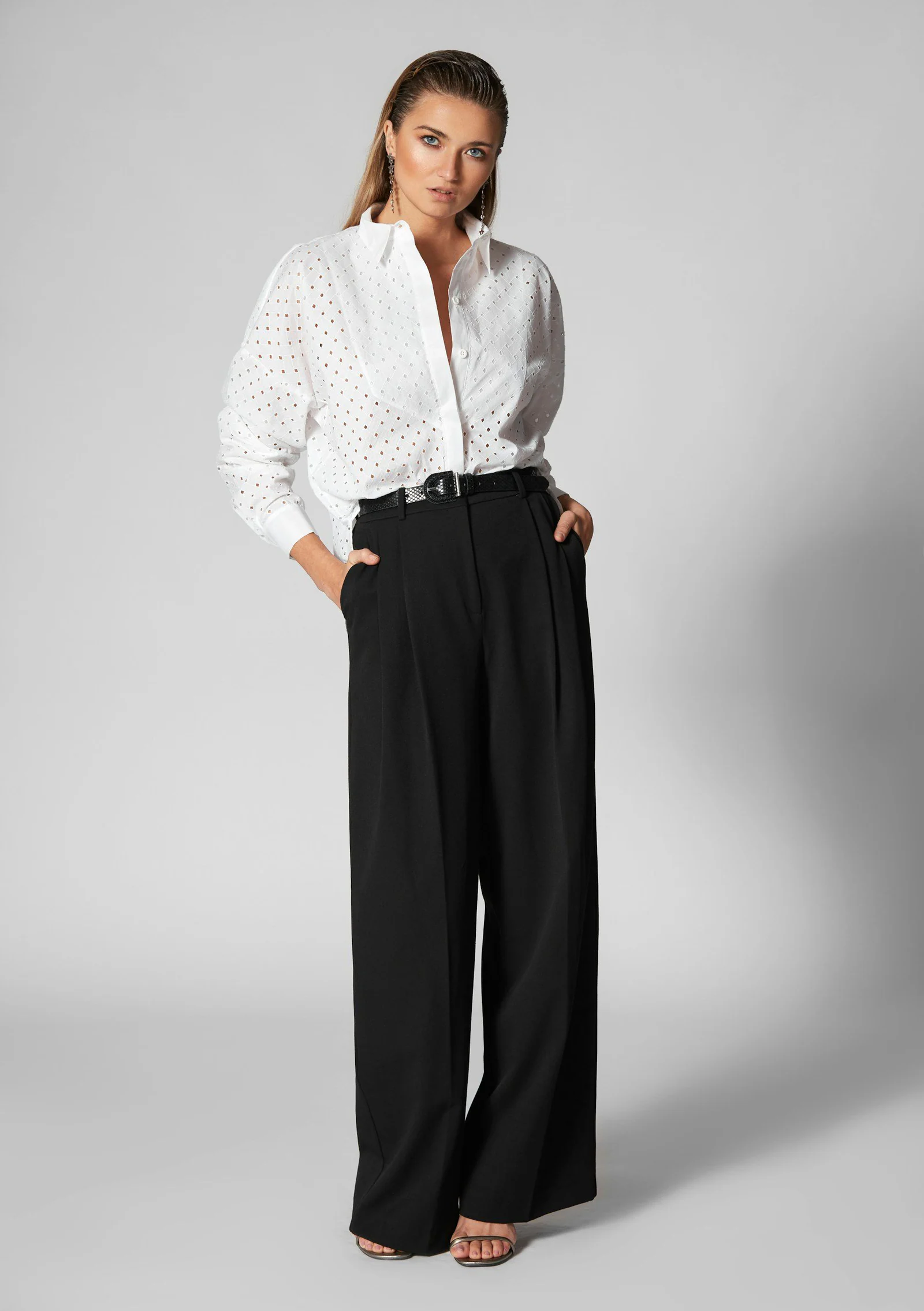 Woman in white shirt and black wide leg pants