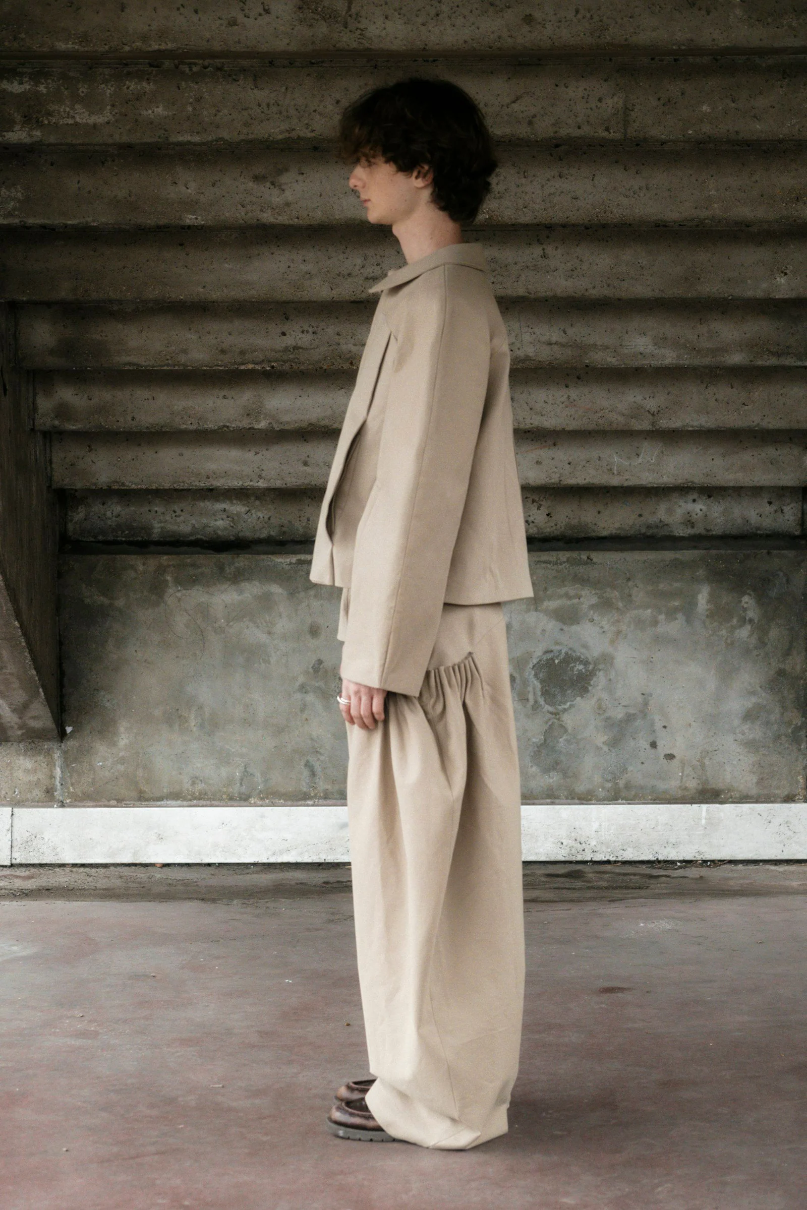 A person wears neutral colored clothing