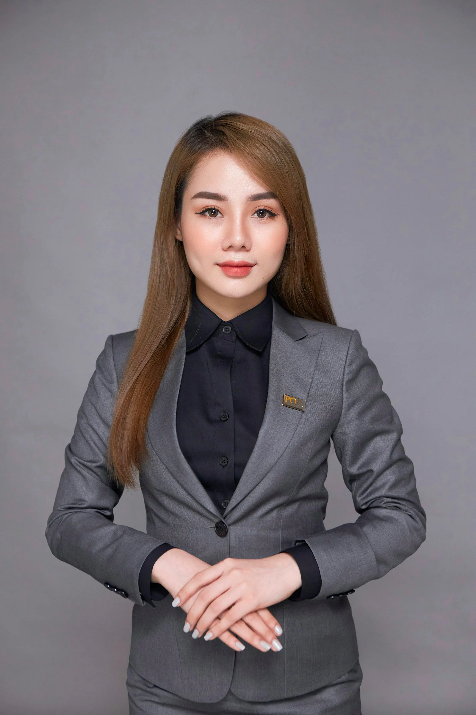 Woman in grey blazer business portrait