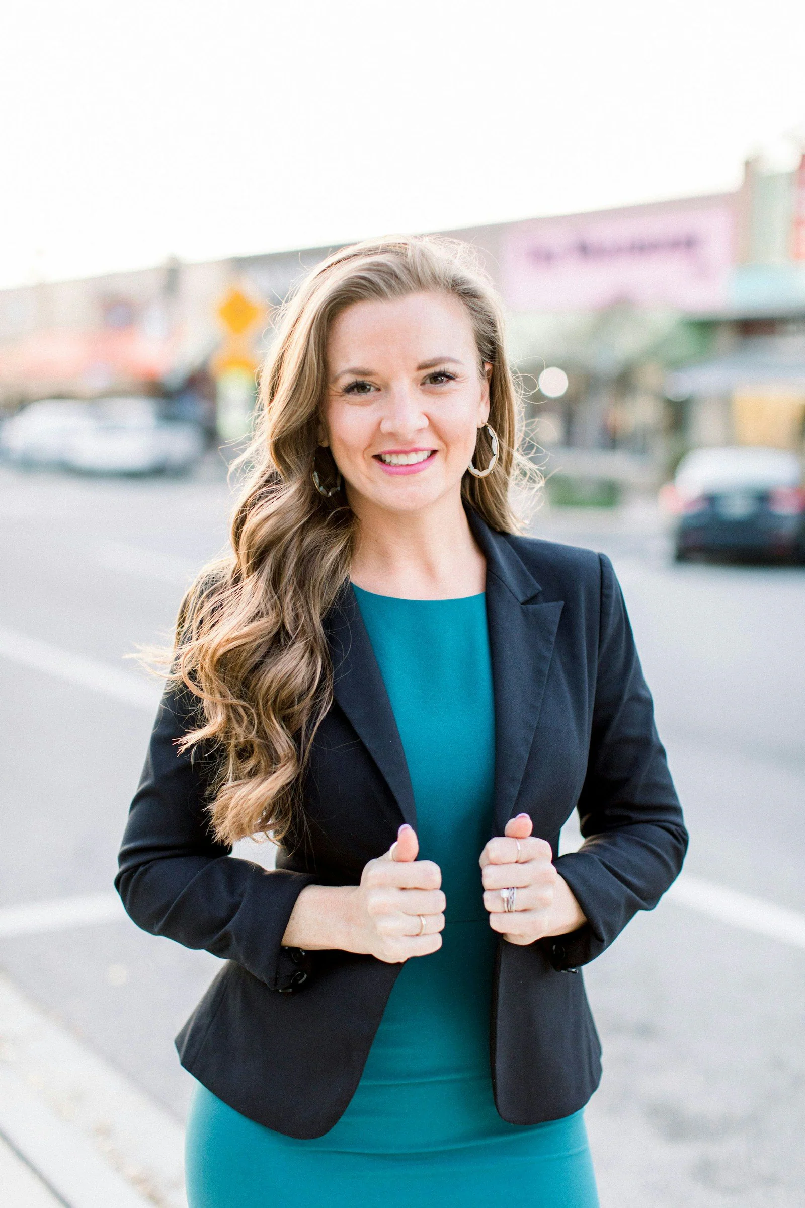 Woman in black blazer smiling