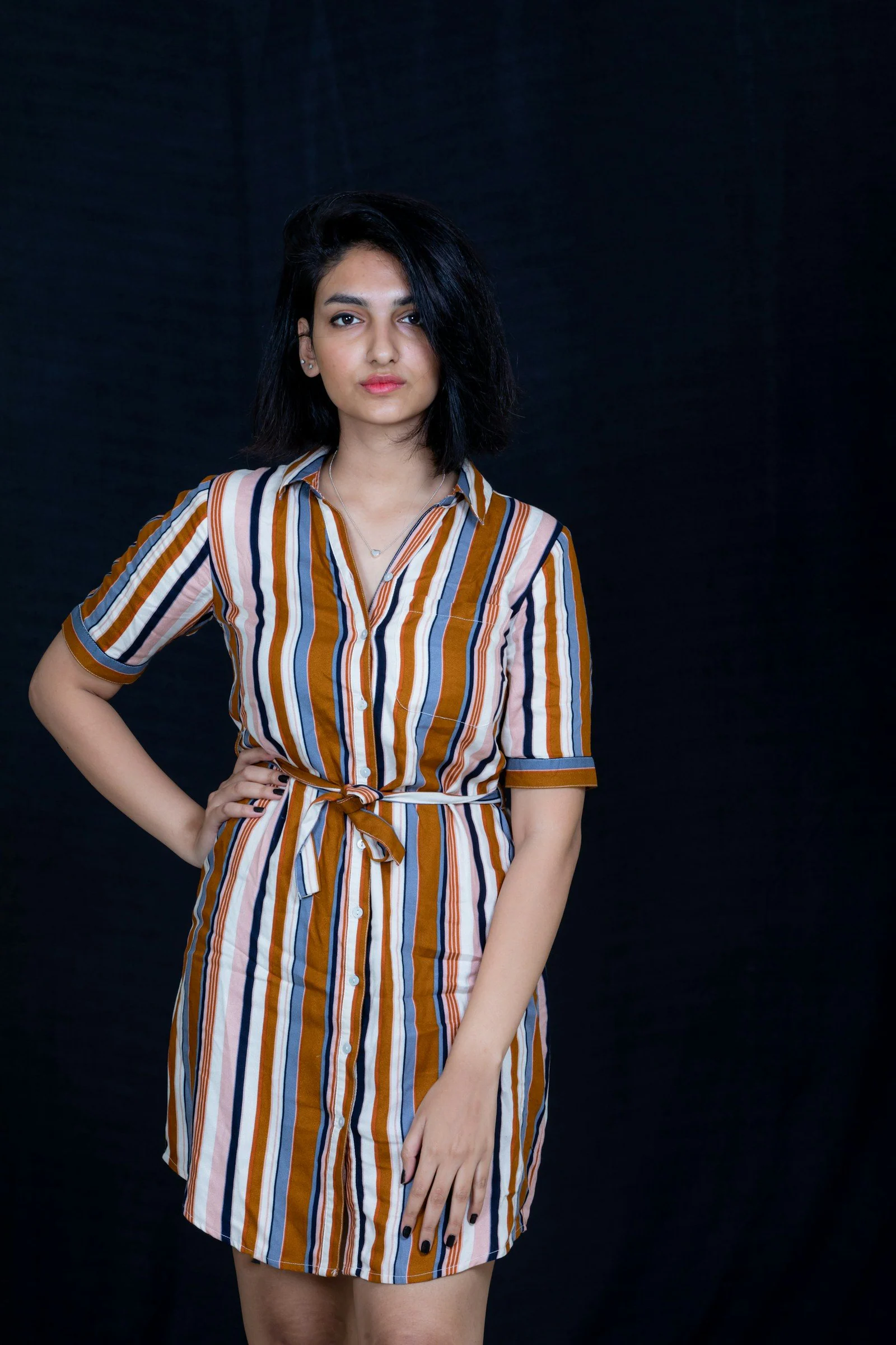 A woman standing with her hands on her hips