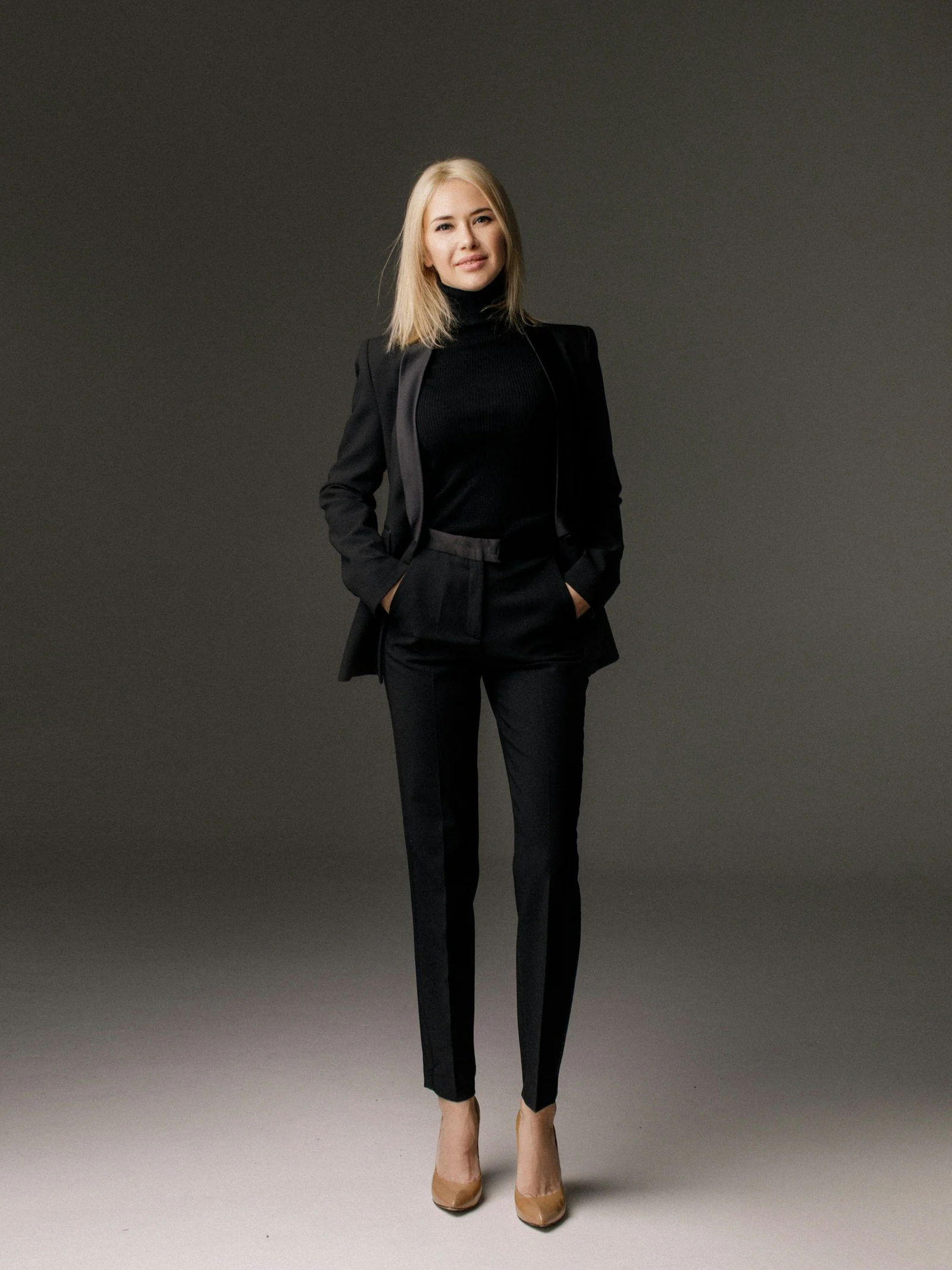 Woman in a black tailored trouser suit
