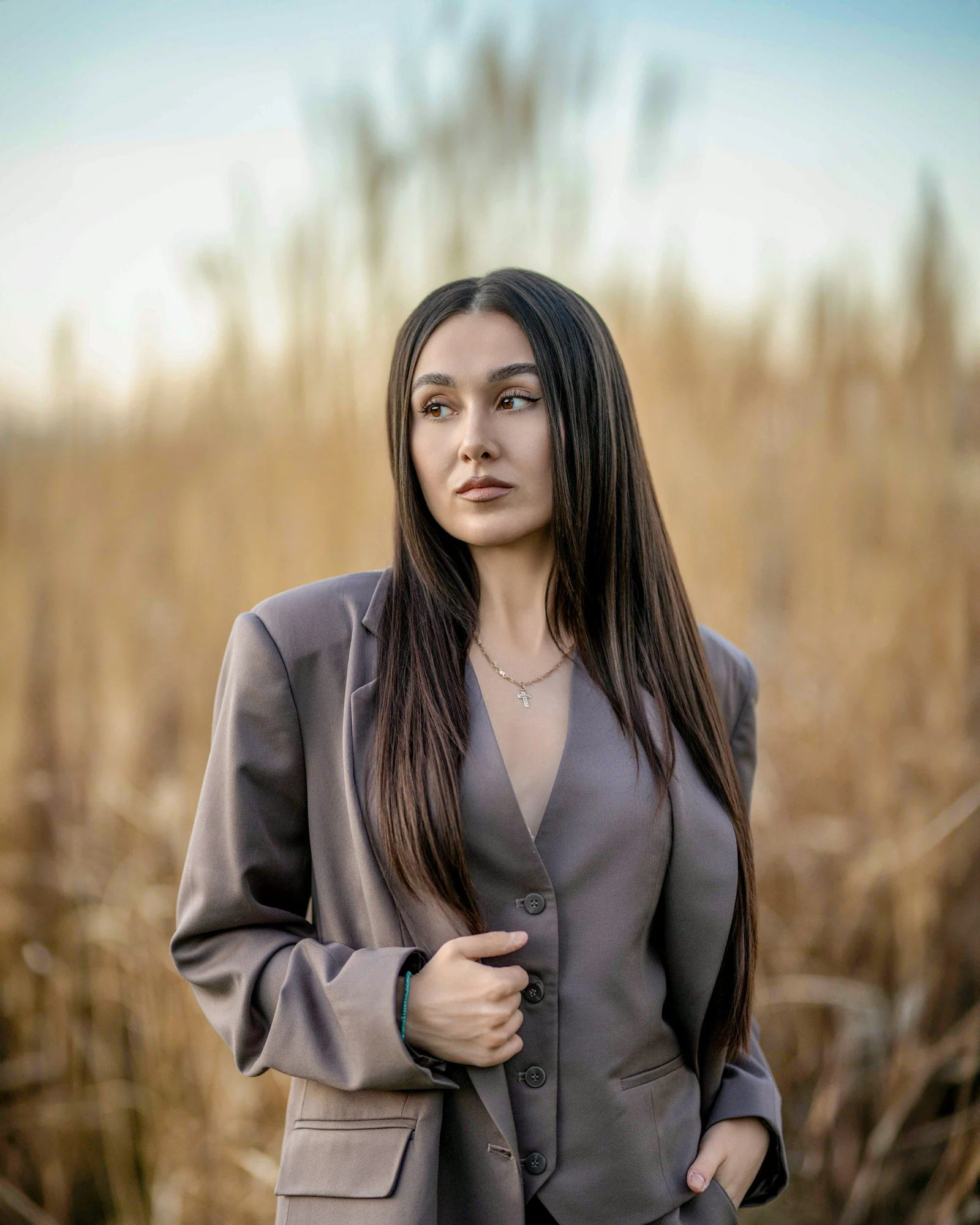 A woman standing in a field of tall grass