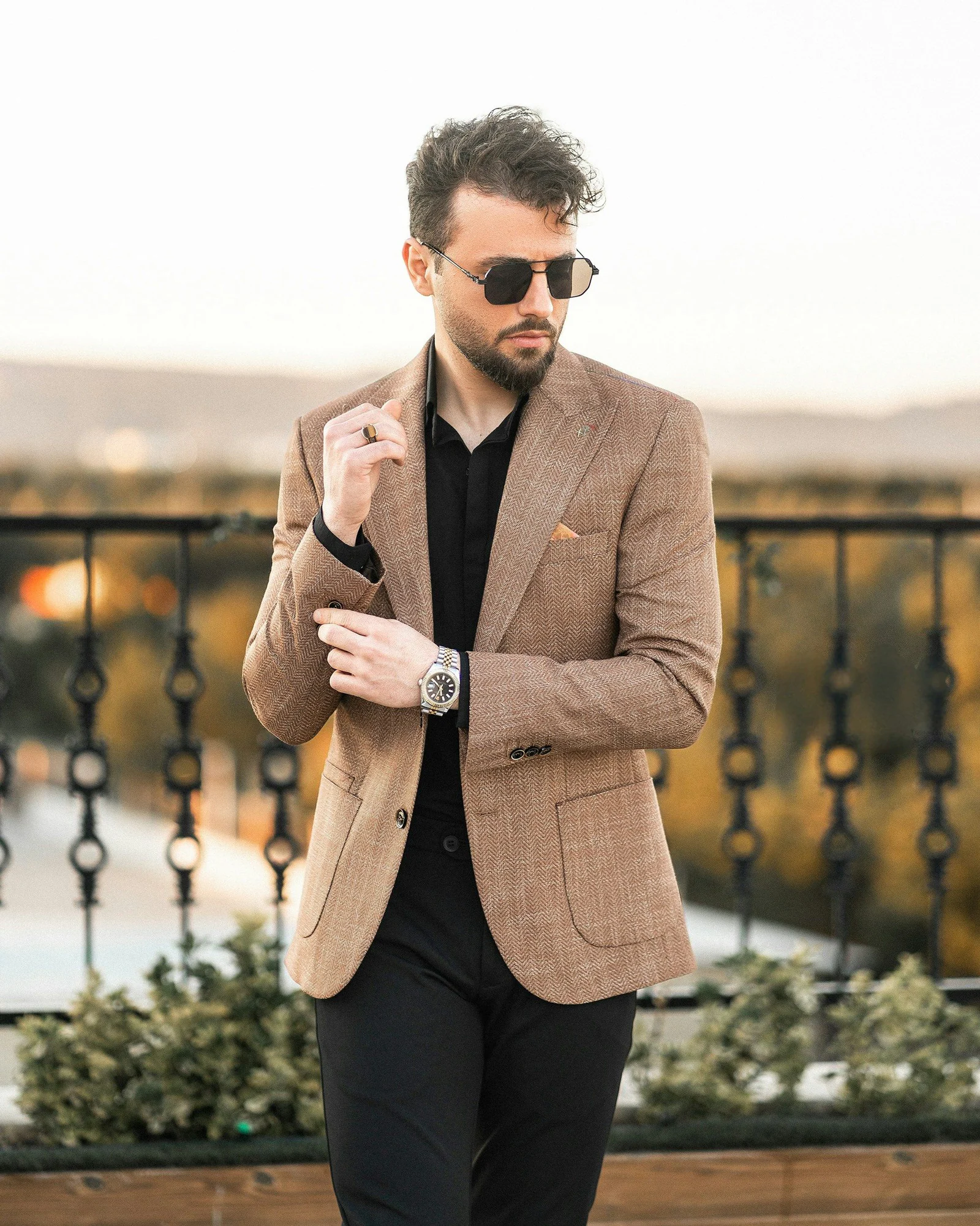 Tan check jacket over a black shirt