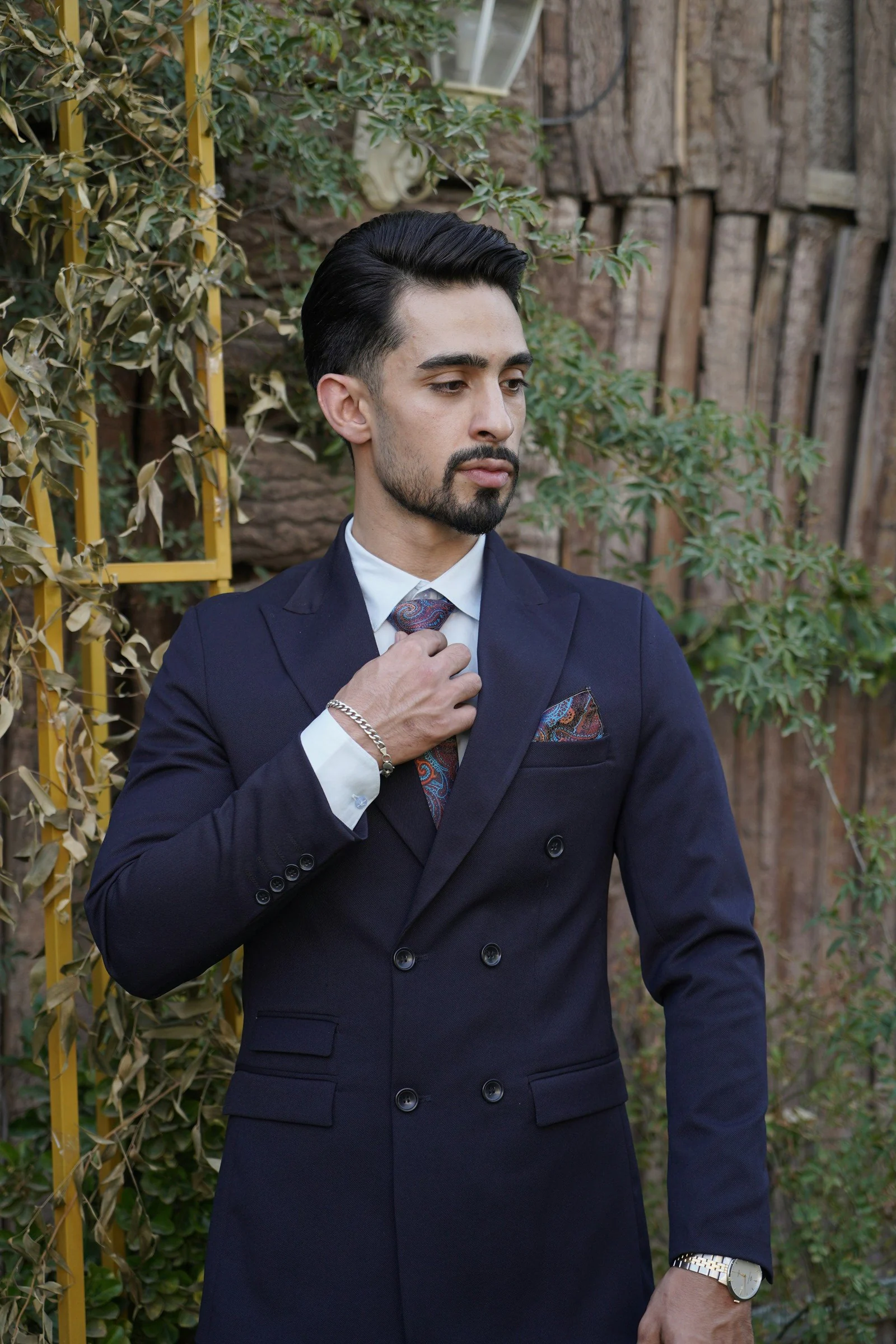 Navy double-breasted suit, adjusting the tie