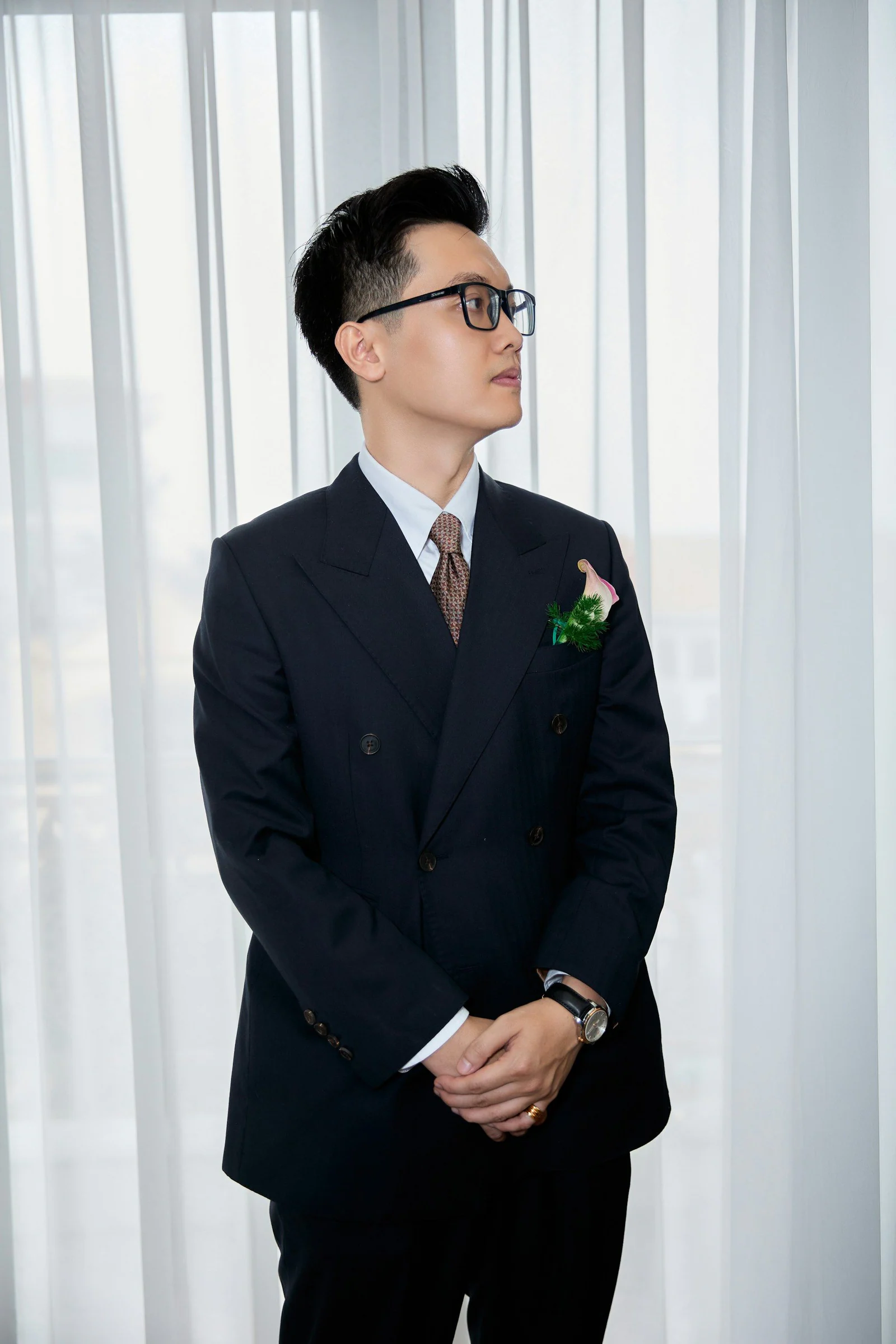 Navy double-breasted suit with a buttonhole flower