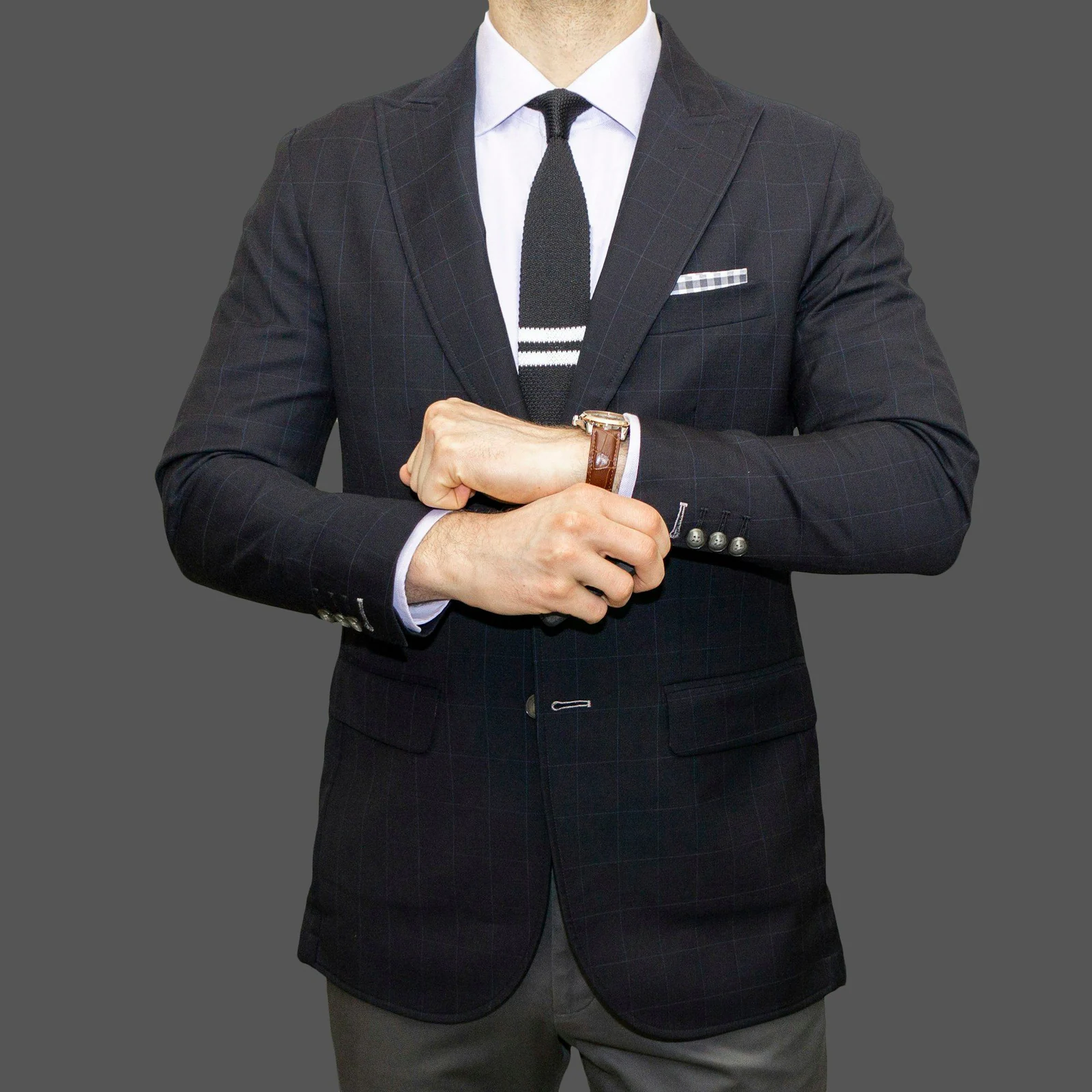 Navy formal jacket with a tie bar and pocket square