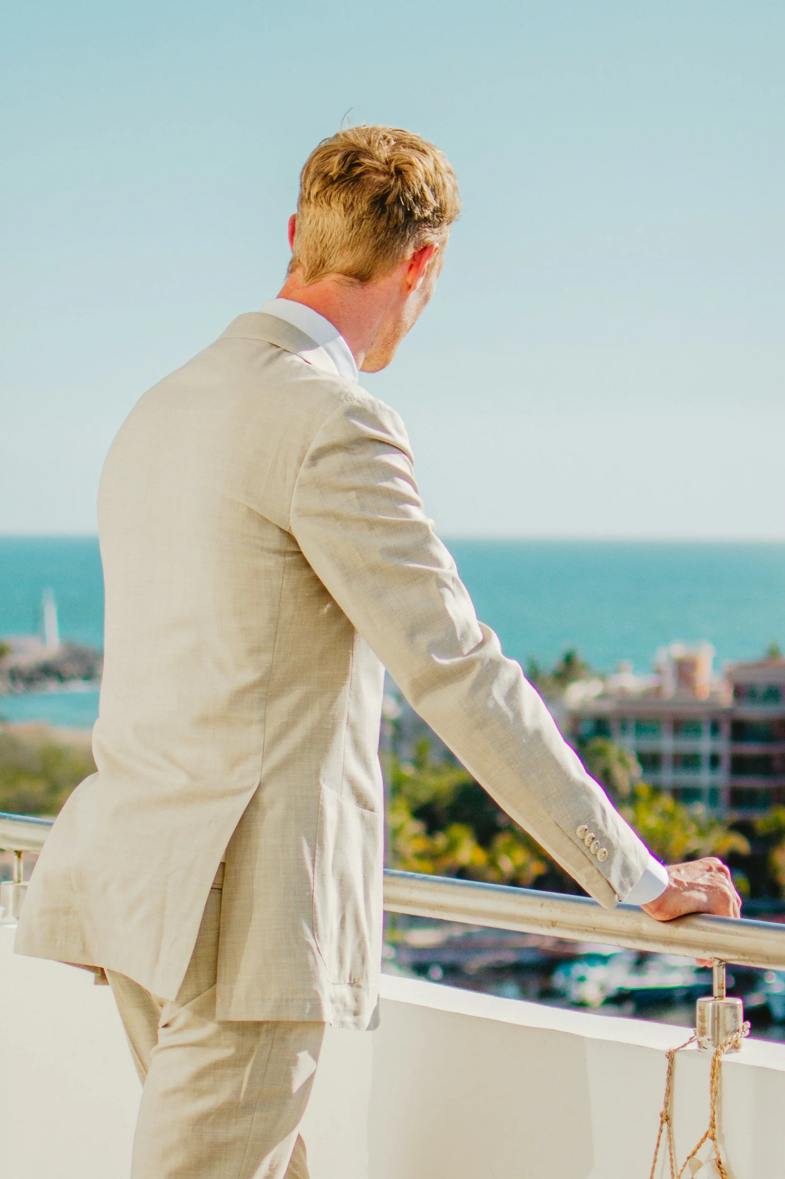 Light linen suit, looking out to sea from a balcony