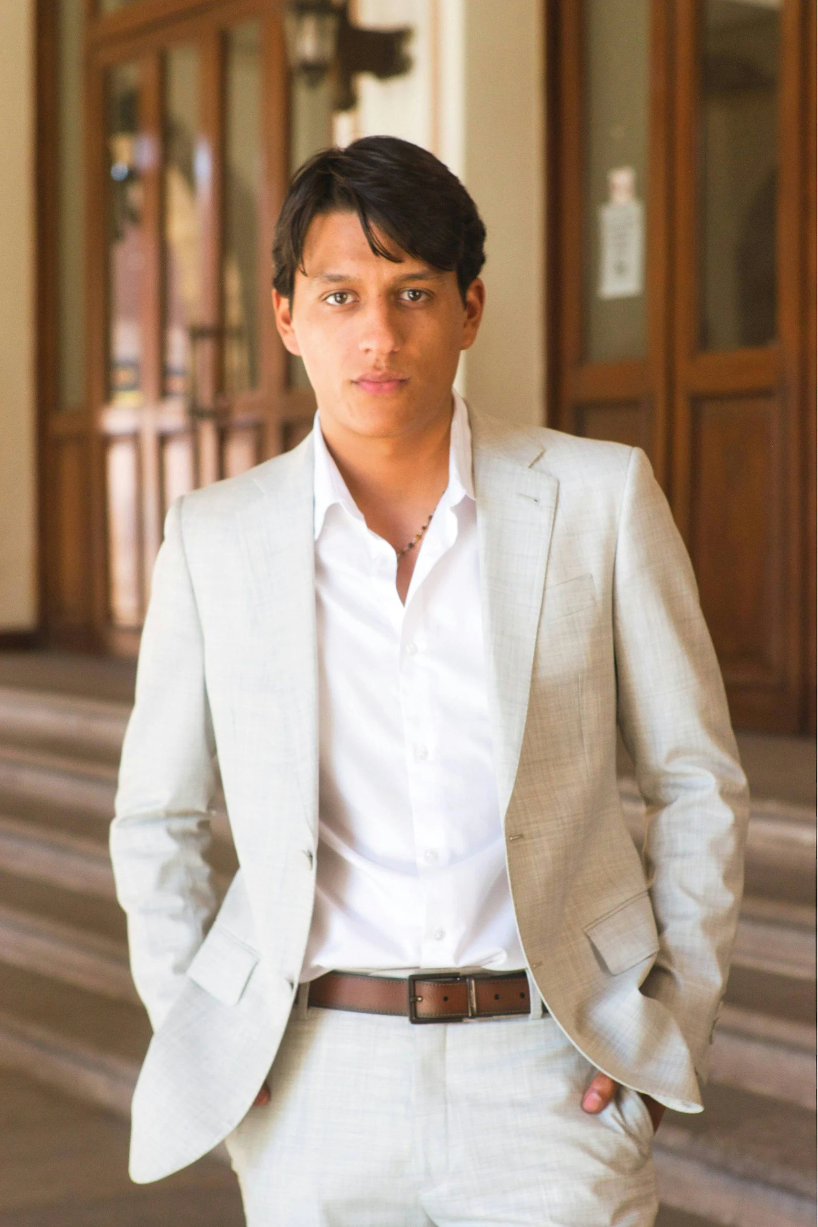 Ivory linen suit with an open-collar white shirt