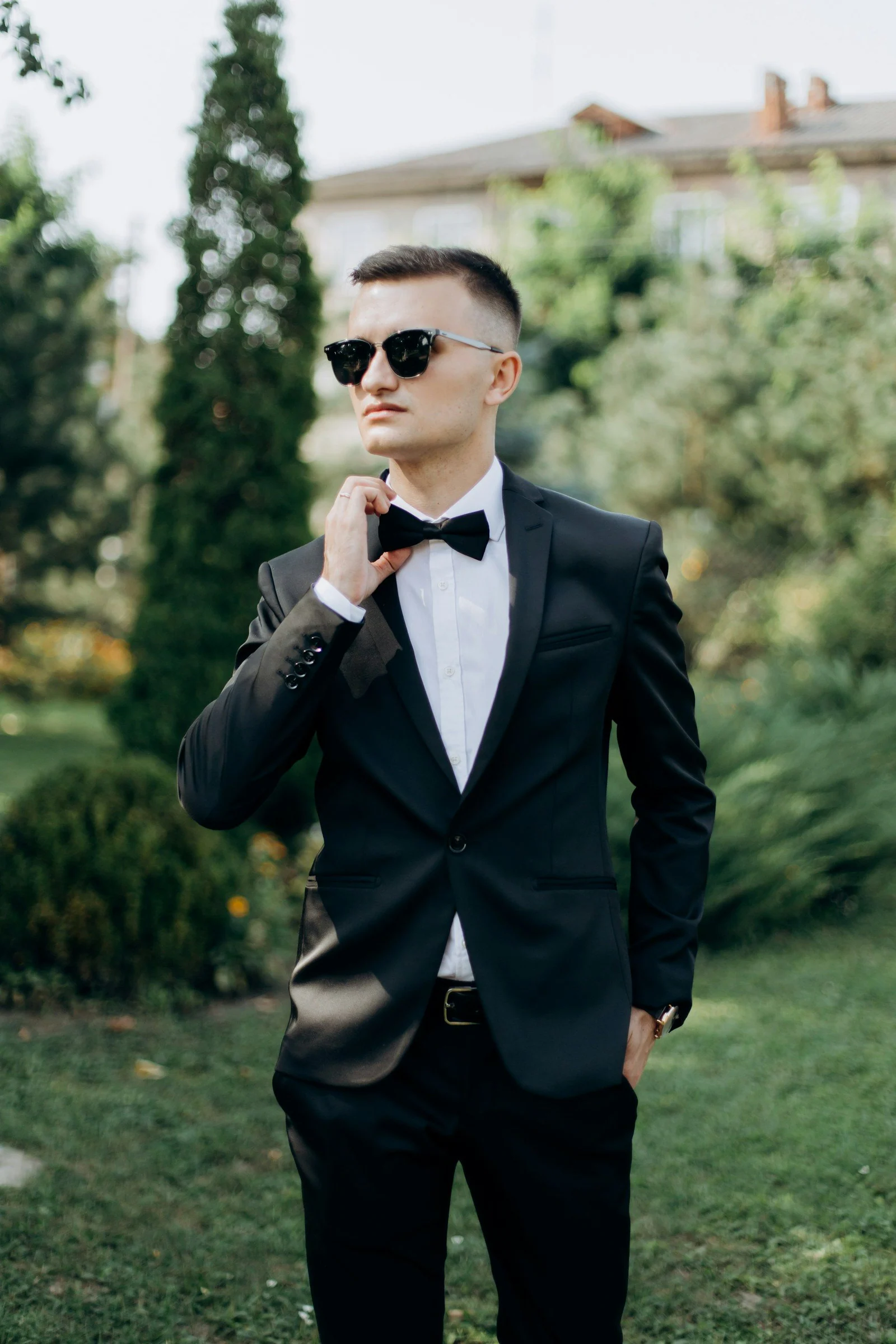 Black dinner suit and bow tie in a garden