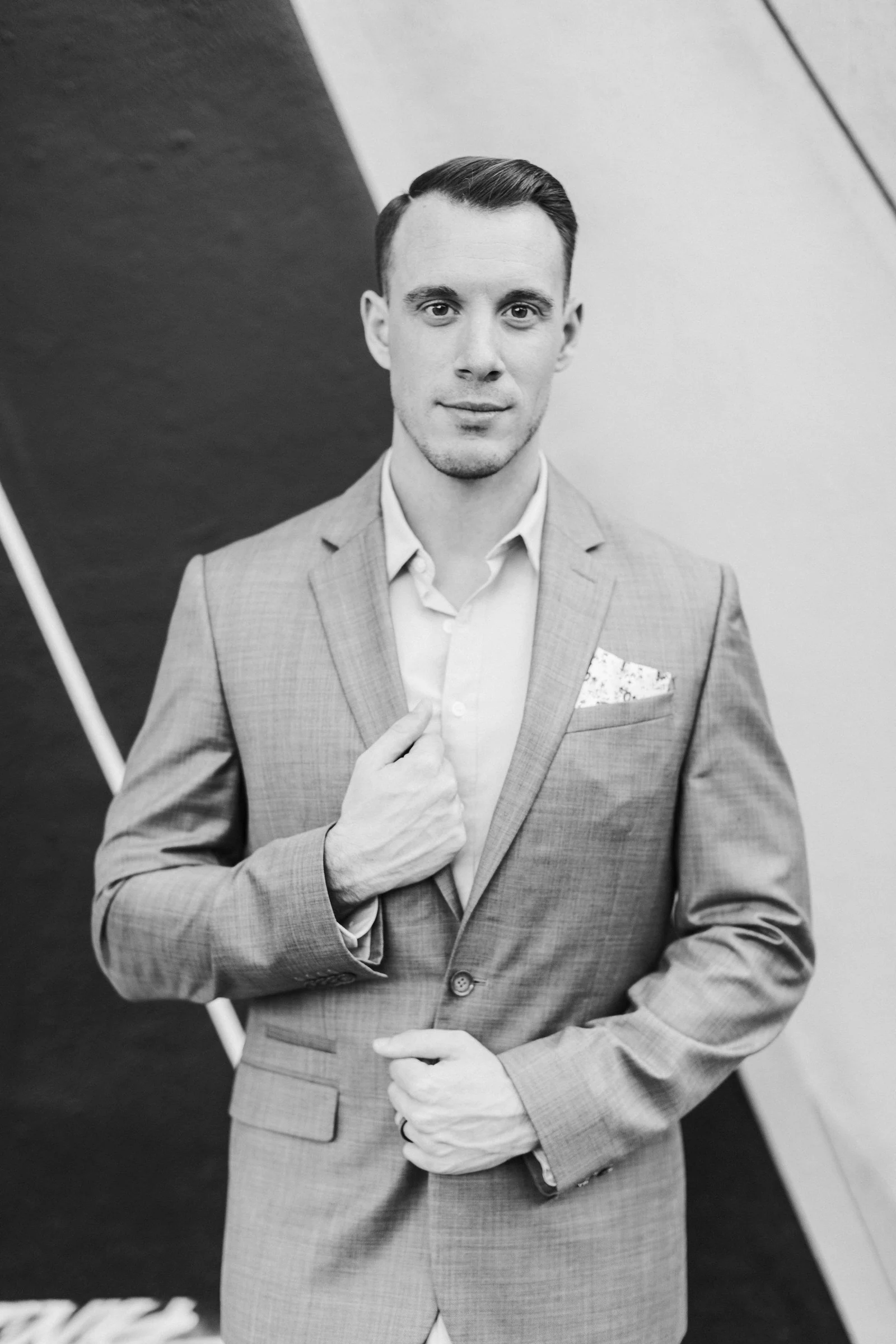 Light grey two-piece suit with pocket square, black and white portrait