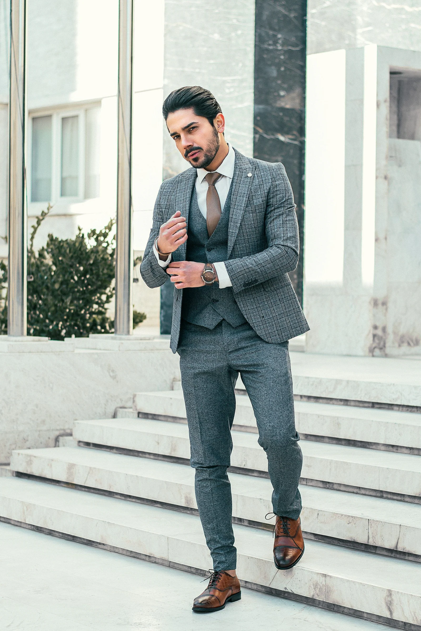 Blue-grey two-piece suit on a white staircase