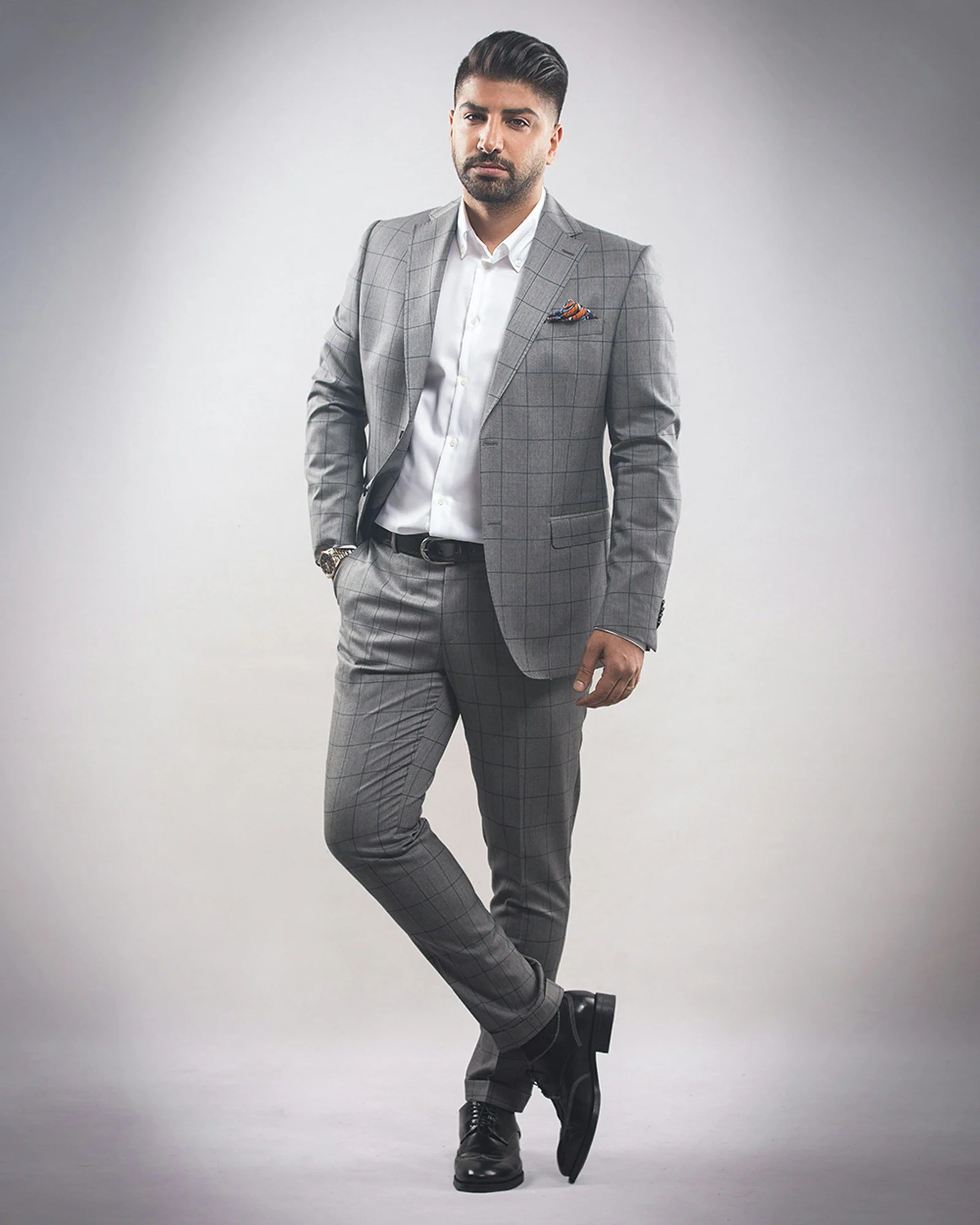 Grey two-piece suit with an open-collar shirt, full length